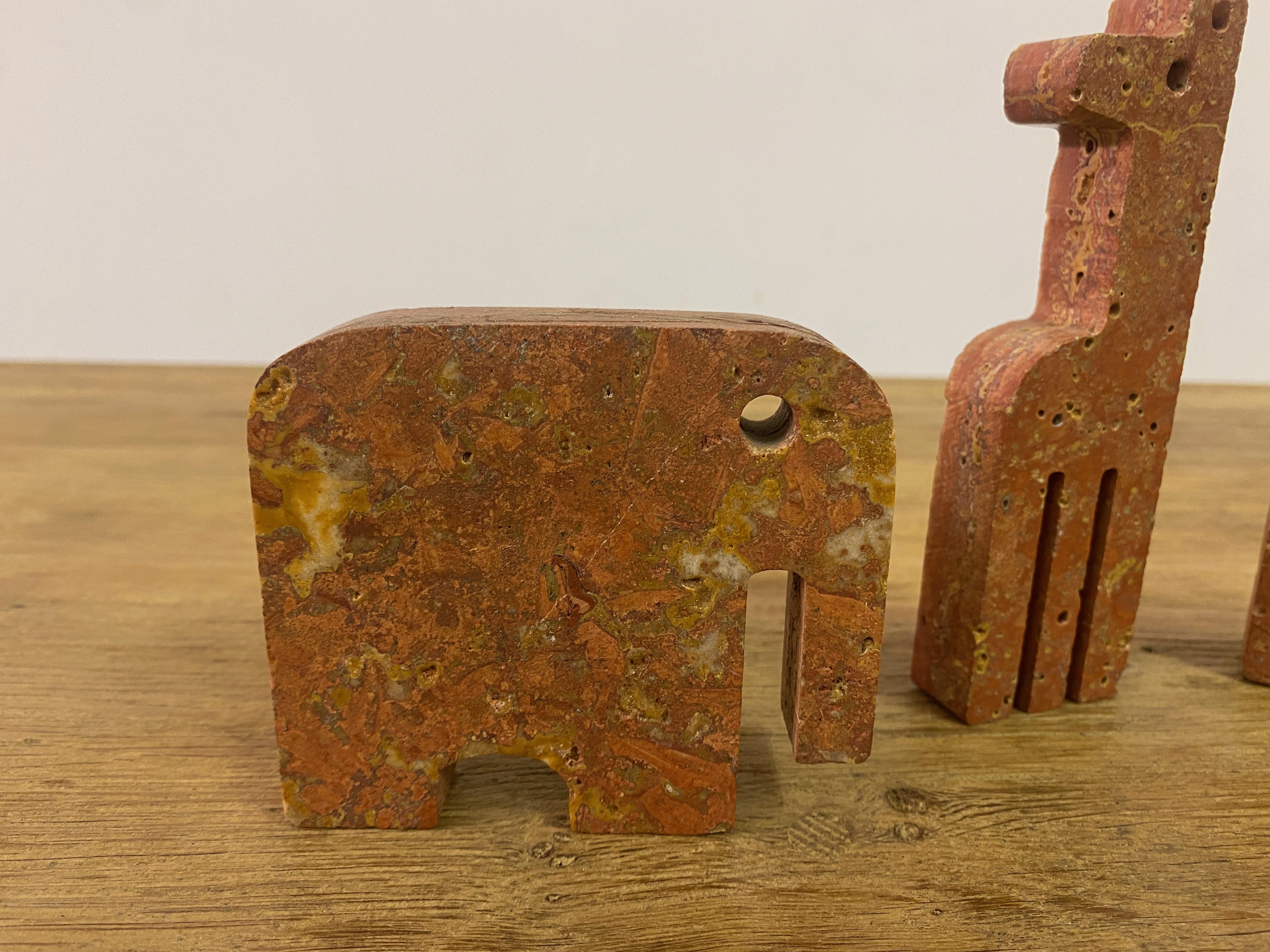 Italian Pair Of Red Travertine Elephant Bookends And A Giraffe For Sale