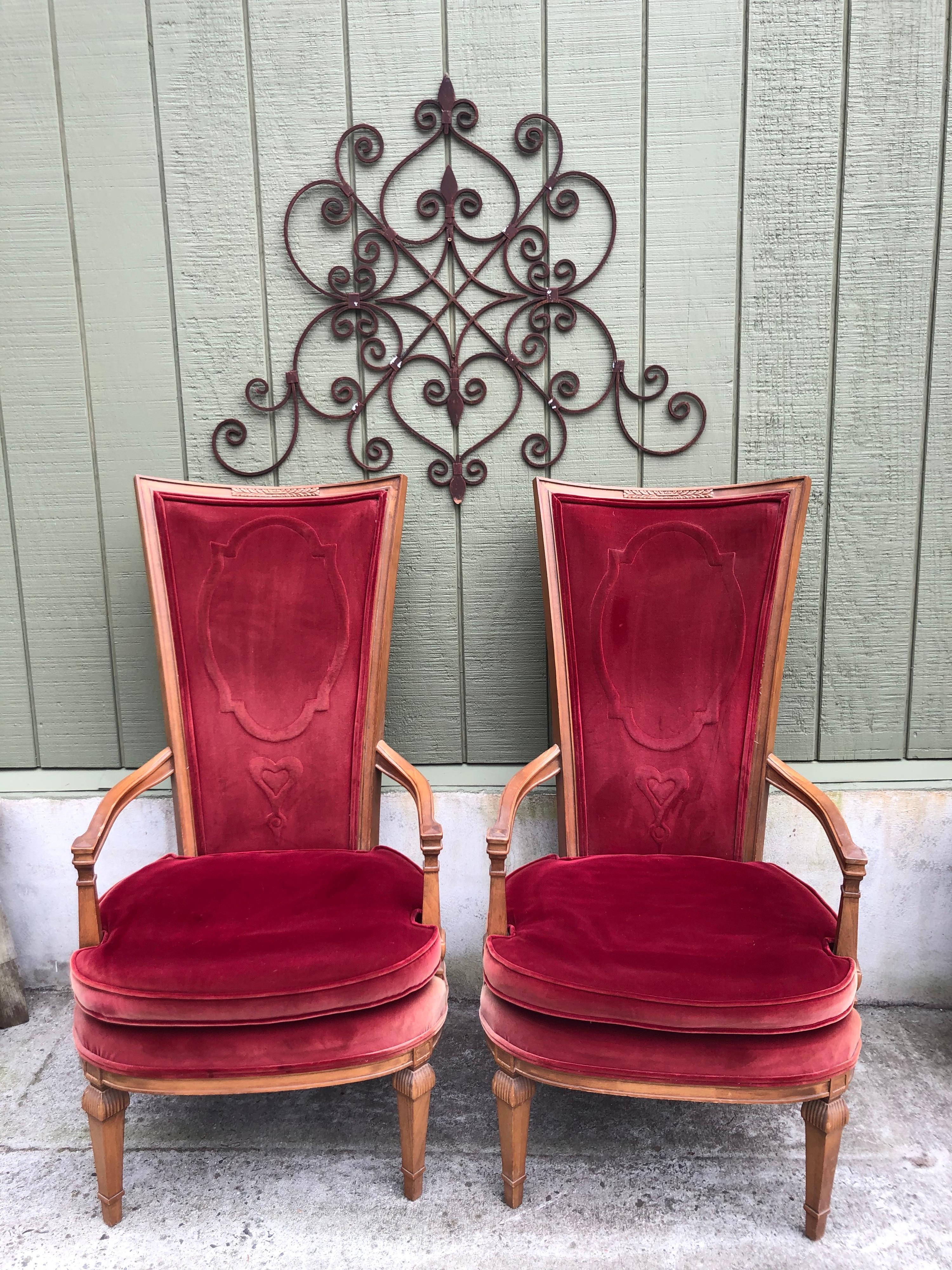 Pair of red velvet Hollywood Regency highback chairs. High glamour appeal to these his and hers throne chairs. Note the quilted red hearts in the velvet design. Show the love for your valentine with these beauties.