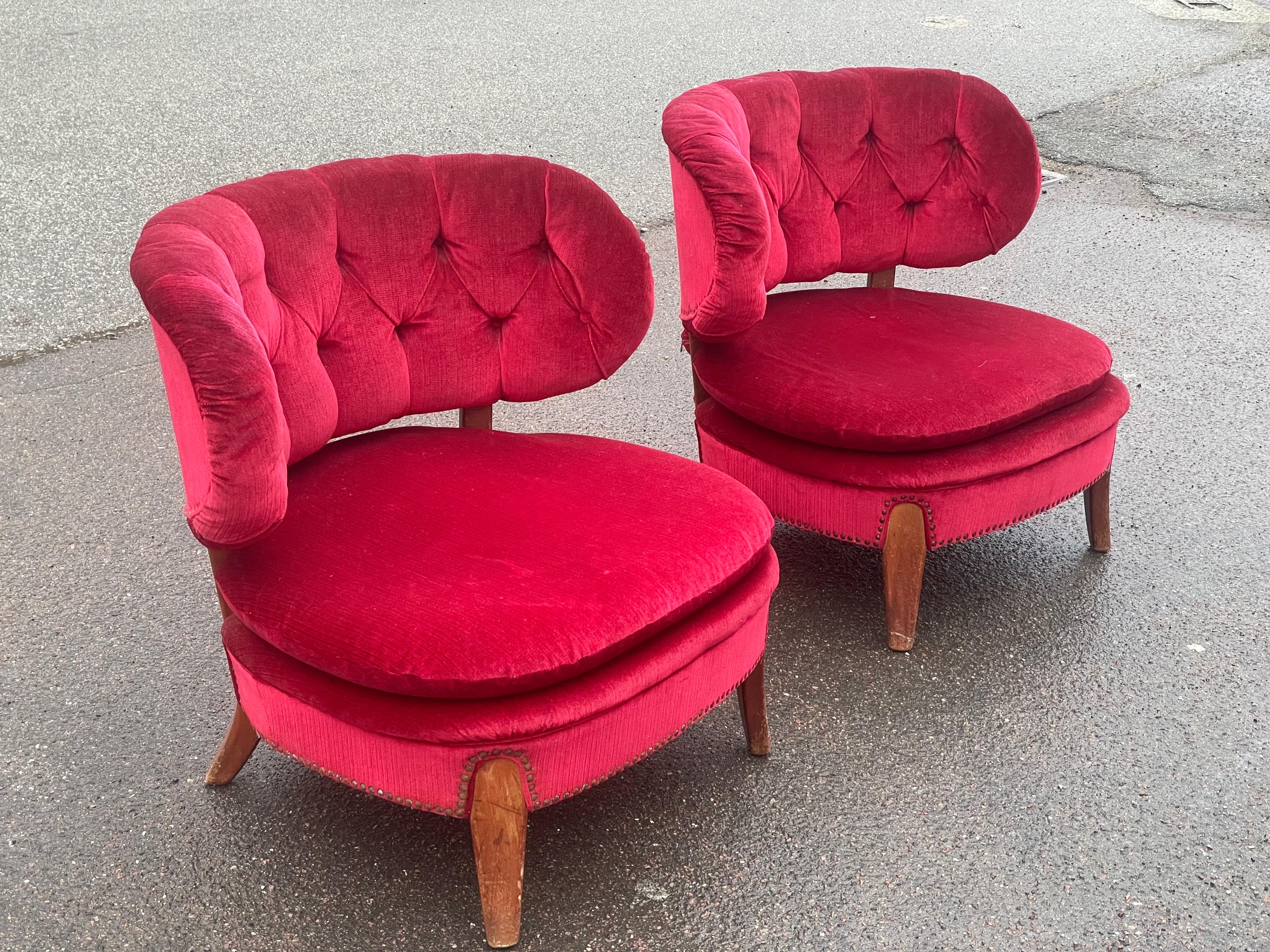 Pair of lounge chairs by Otto Schulz for Boet, Sweden, embodies his signature blend of elegance and functionality. Designed in the 1936, the chairs feature soft curves, tufted backs, and luxurious dark red velvet upholstery, highlighting Schulz’s