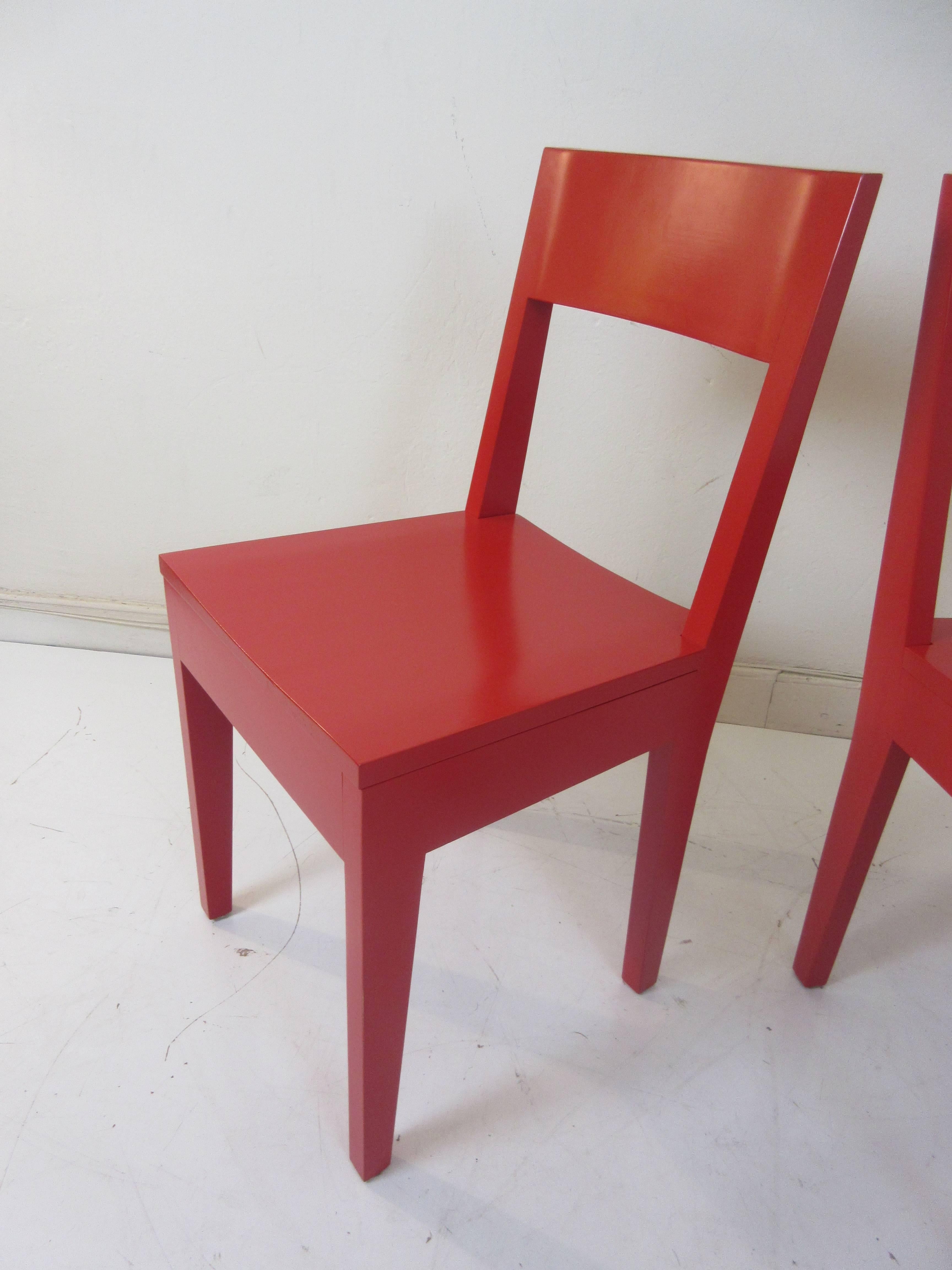 Bright red solid wood chairs finished in a red lacquer. Bought in the 1990s from a Philadelphia design furniture store Usonia.