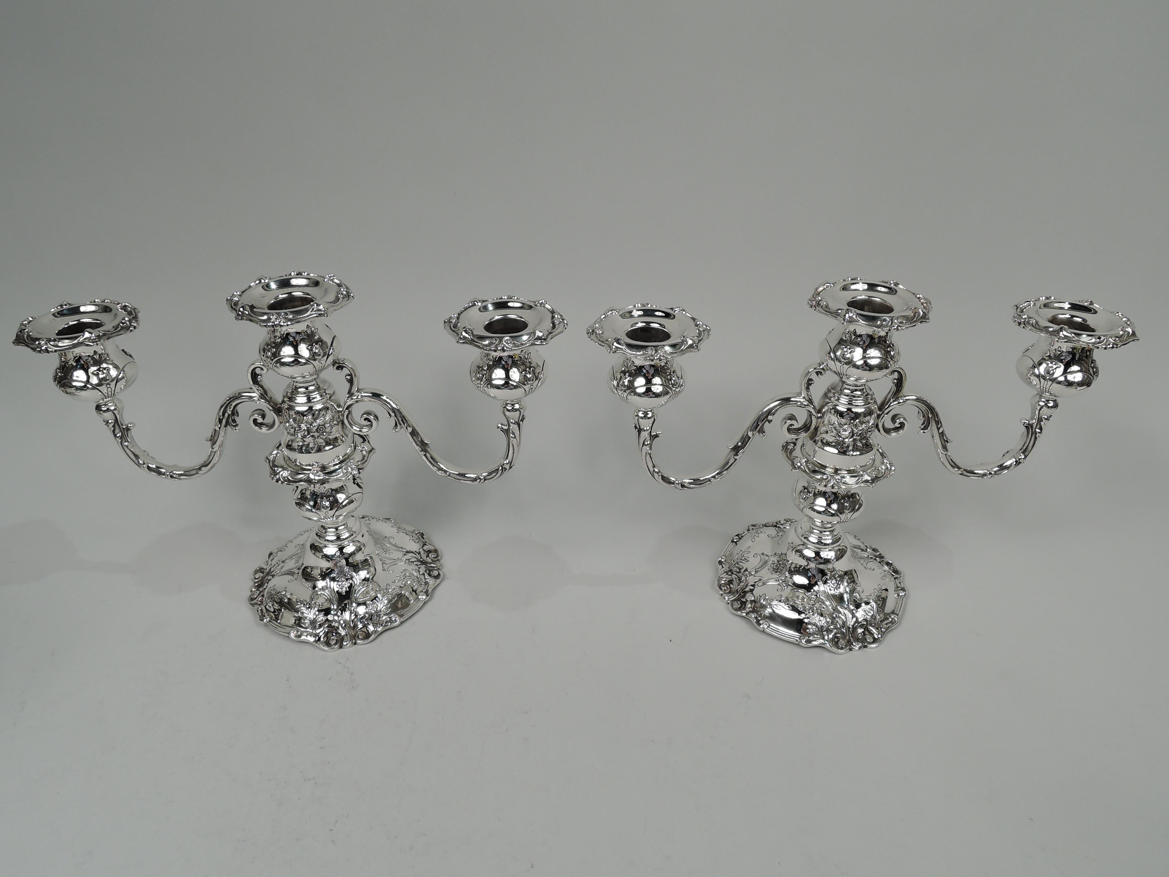 Pair of Francis I sterling silver low 3-light candelabra. Made by Reed & Barton in Taunton, Mass. in 1952. Each: Central socket on bell-form base to which are mounted 2 split-mounted and leaf-wrapped arms, each terminating in single socket. Shaft