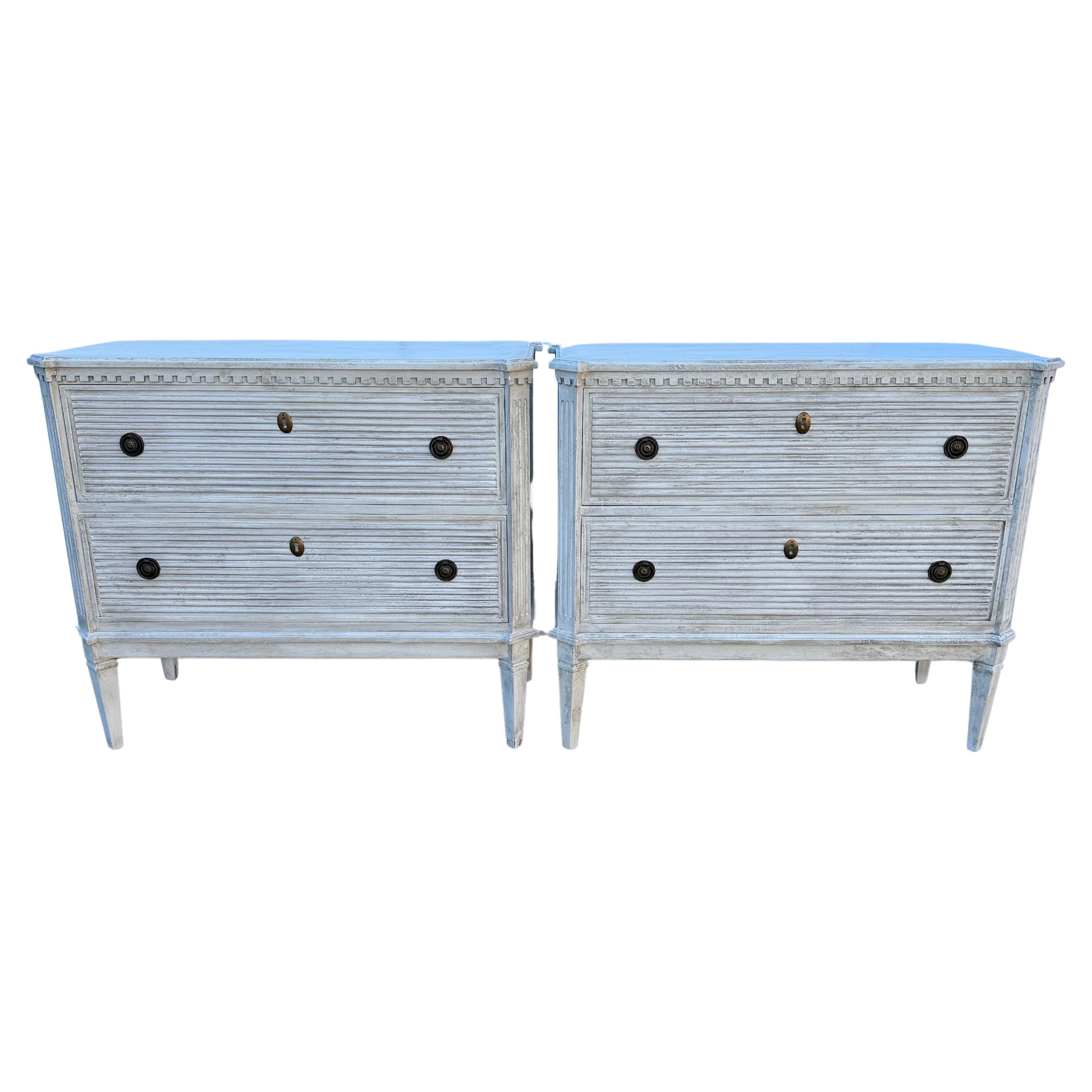 White Painted Gustavian Style Chest of Drawers, A Pair

Pair of white hand painted Gustavian style chest of drawers constructed from solid wood with a hand-applied distressed finish with brass ring hardware.  These classic Swedish style two drawer