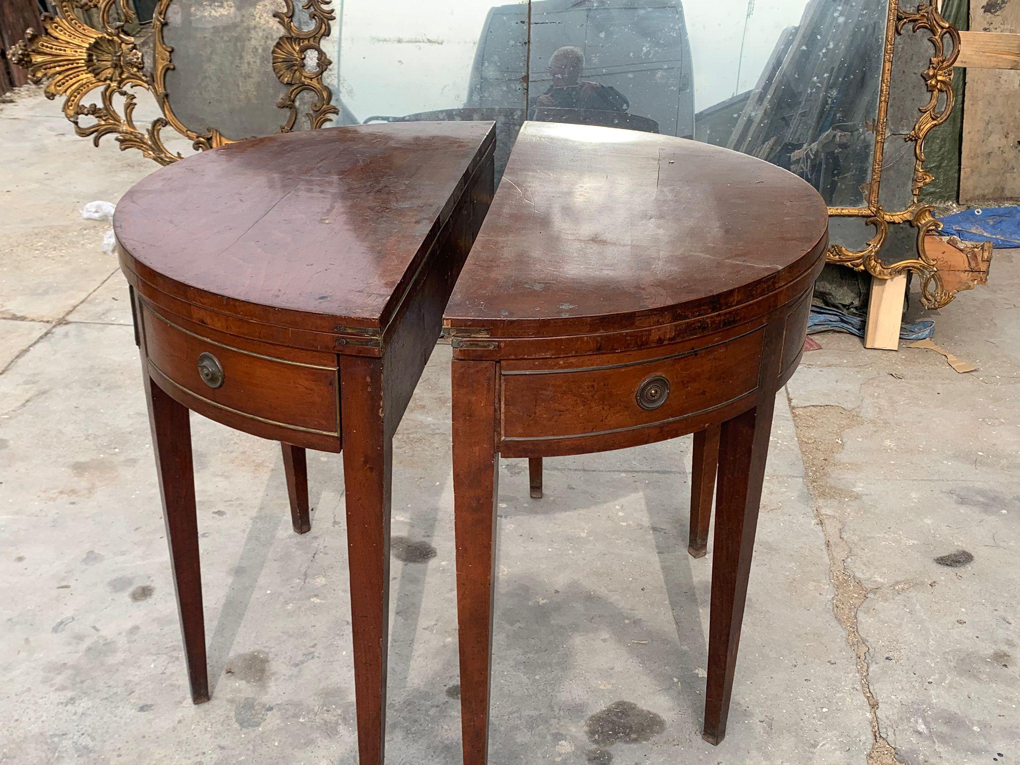 Antique Pair of refined consoles, half-moon shaped wooden game tables, Complete with central drawer and opening top with green fabric typical of game tables, they are half-moon shaped so they can be joined to form a single round table.
The legs are