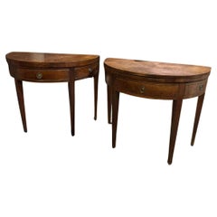 Pair of refined consoles, half-moon shaped wooden game tables, Italy