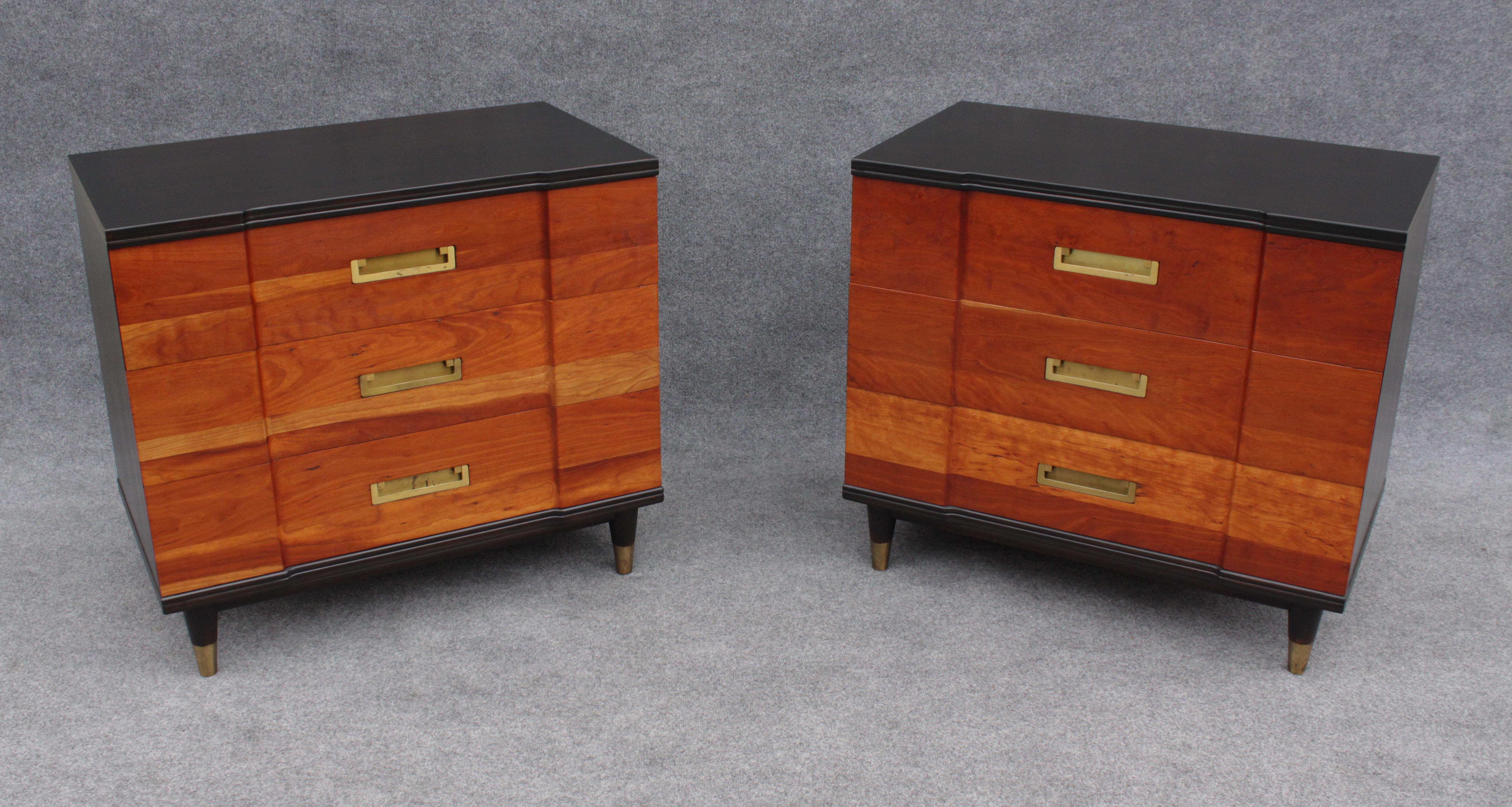 Designed by John Clingman, this line of furniture was produced by John Widdicomb. Made with solid walnut panels throughout, these dressers have been refinished. The tops, sides, backs, and other accents have been stained a very dark brown, while the