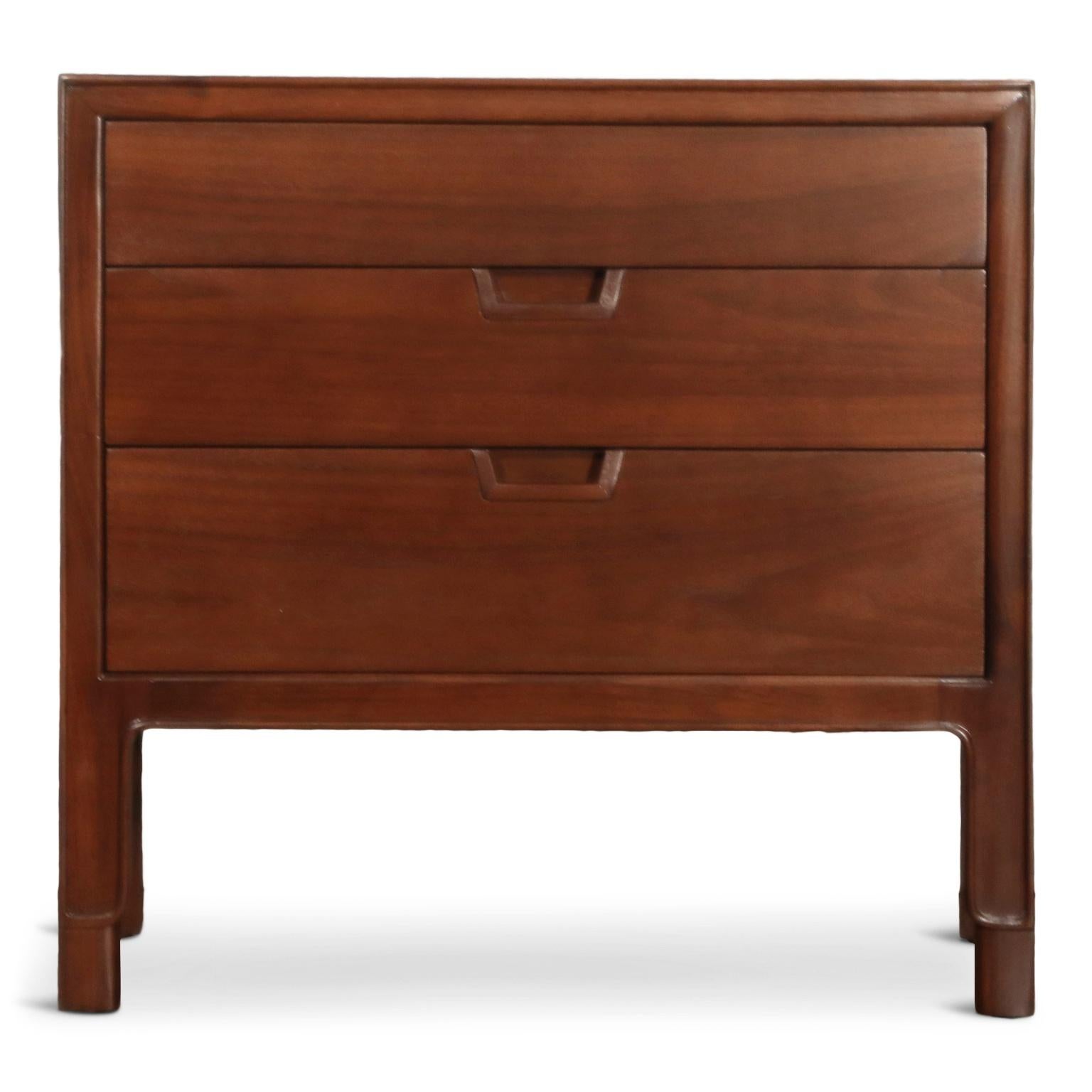 A beautifully restored pair of nightstands, or can also be used as end tables/sides tables, by John Stuart for Janus Collection by Mount Airy Furniture Company. Each nightstands features gorgeous wood grain and three sliding drawers with ample