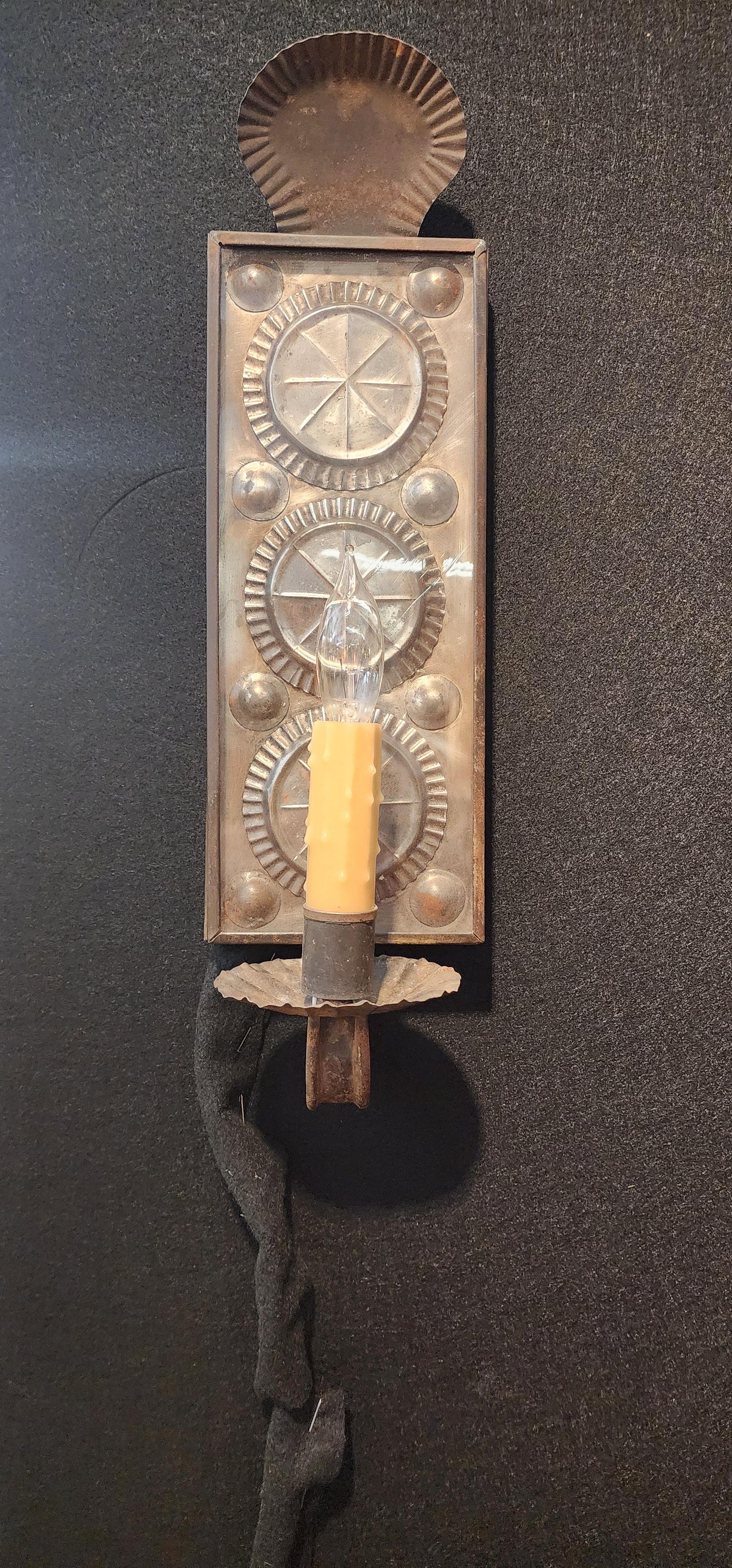 A wonderful pair of tin wall sconce with embossed pewter back-plates, originally formed by pouring melted pewter over cut and polished glass. Late 18th - early 19th century. 
Designed and manufactured by hand in the workshop of Richard