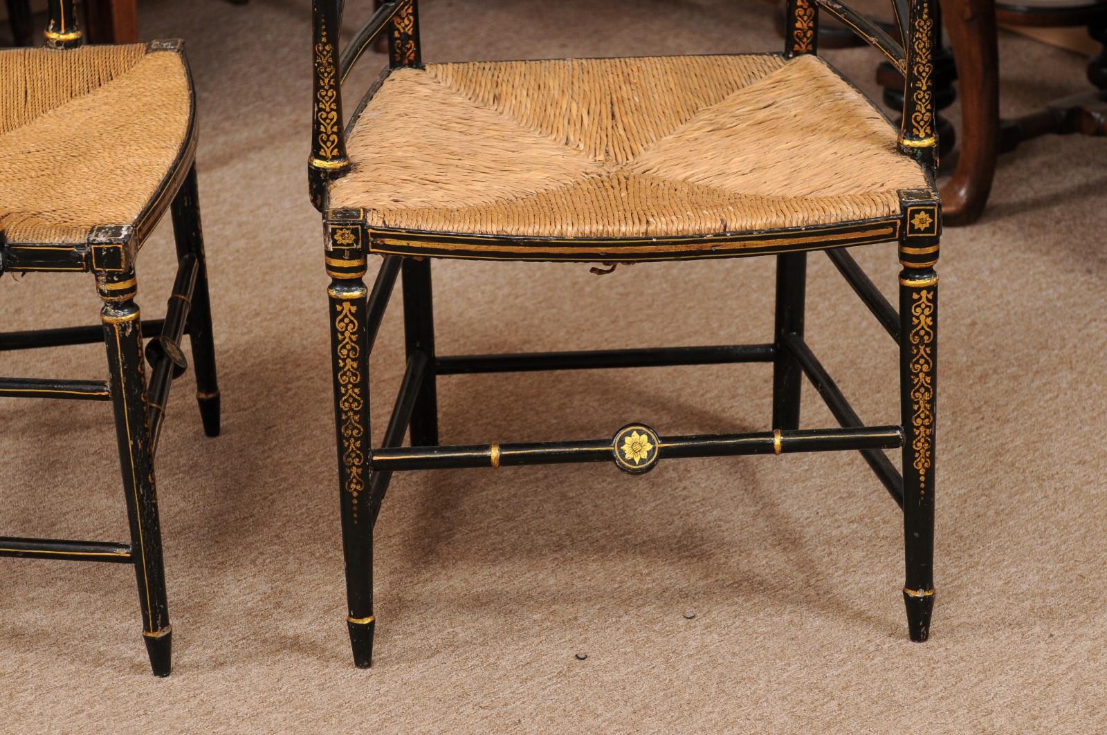 19th Century  Pair of Regency Black Painted Arm Chairs with Floral Decoration & Rush Seats For Sale