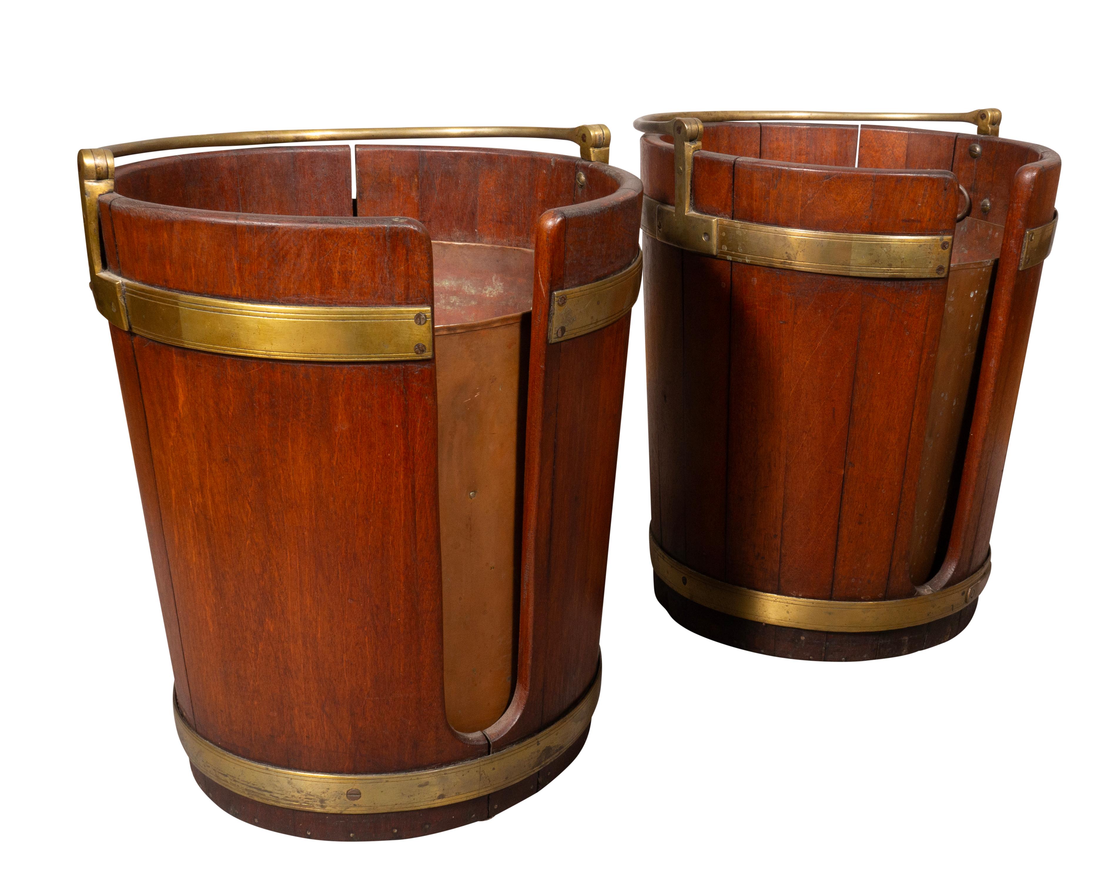 Each Cylindrical with a slat and brass strapping and loop handles. Copper liners.