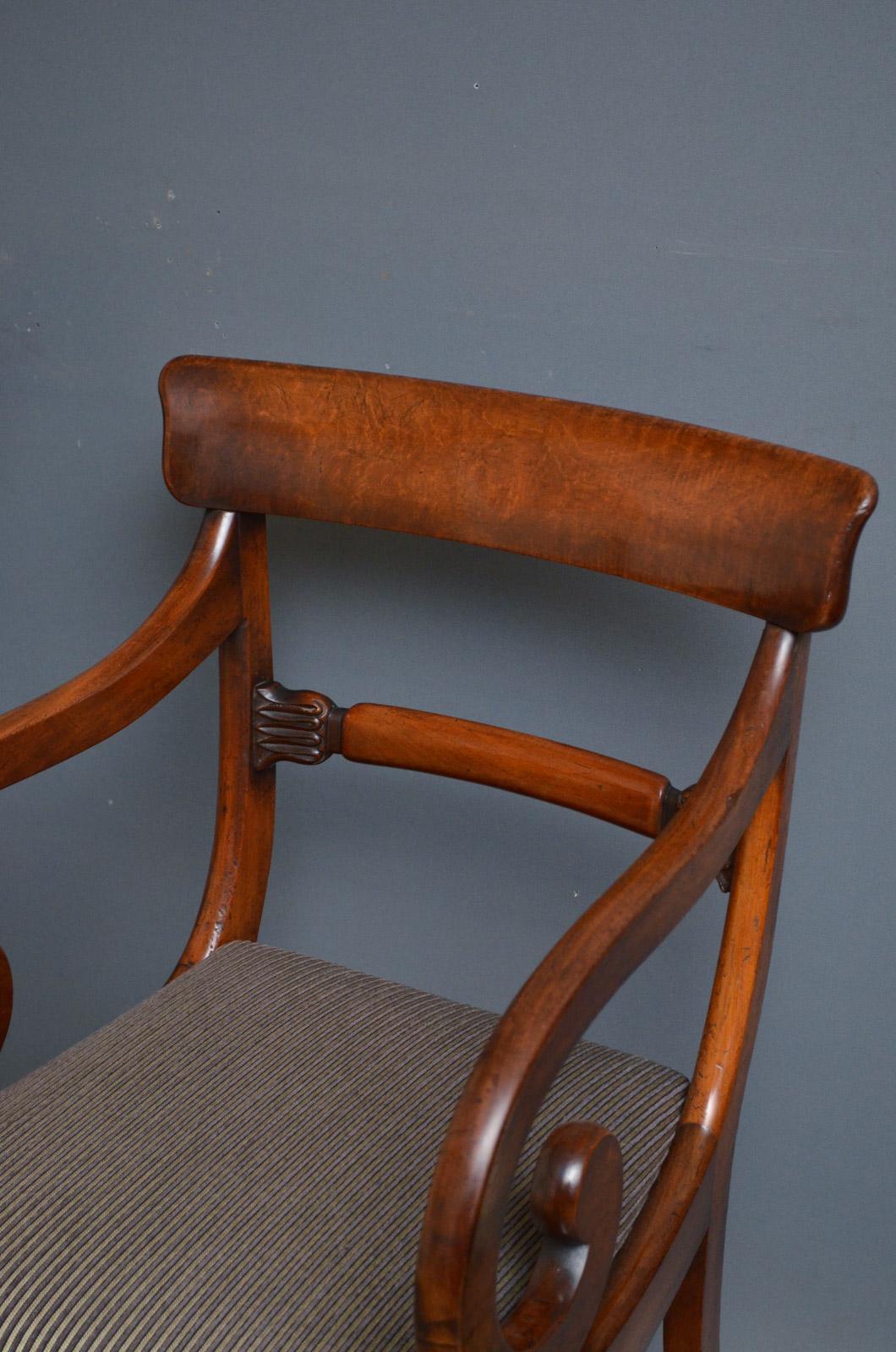 K0378 Fine quality Regency elbow chairs in mahogany, each having shaped top rail with carved mid rails below, drop in seat covered in contemporary fabric and open scroll arms, standing on sabre legs.
These antique armchairs retain original color,