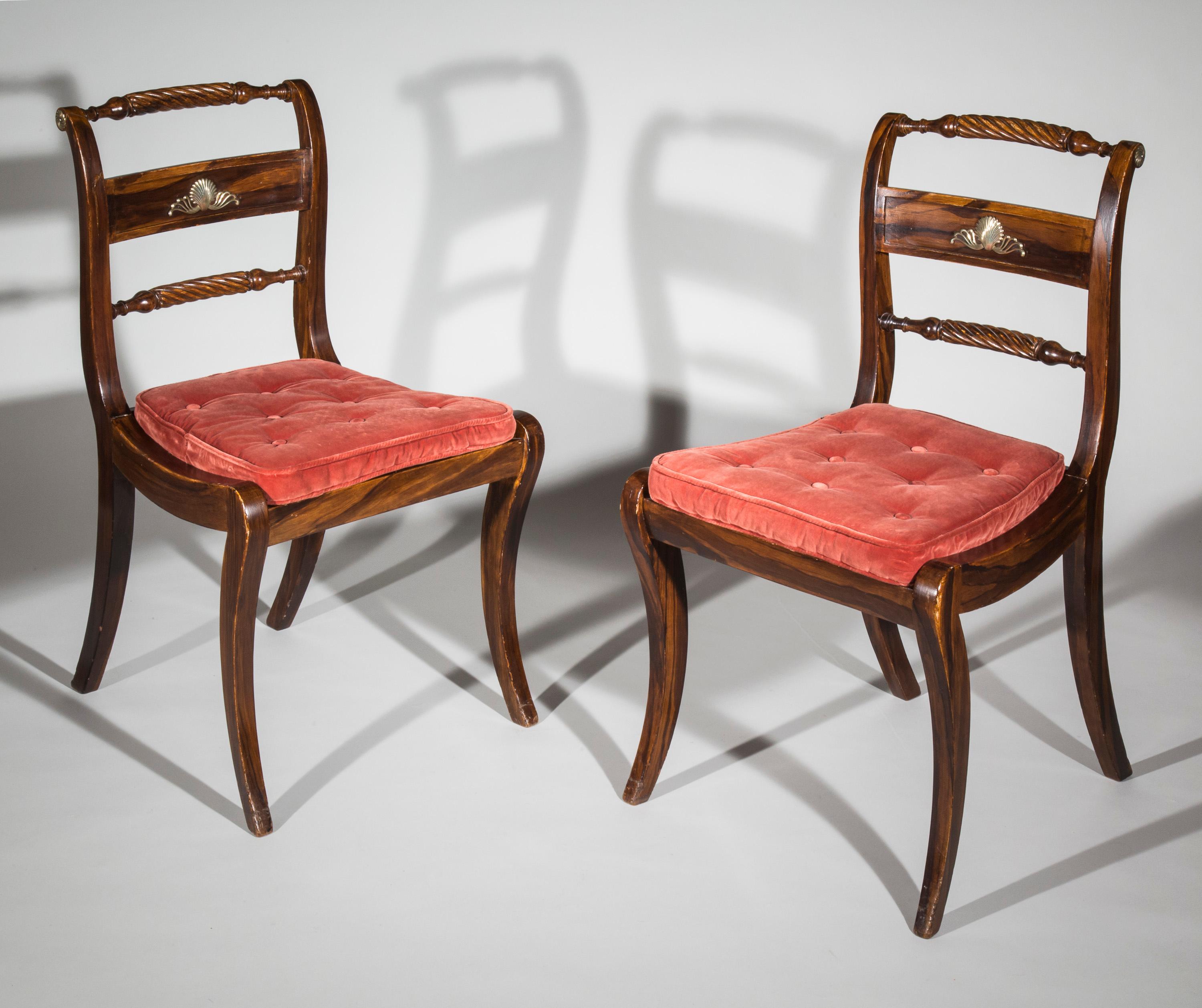 An elegant pair of early 19th century Regency period Klismos chairs, brass-mounted and faux-bois painted.

English circa 1820.

These faux-bois painted and cane-seated chairs, with Grecian boldly curved legs and brass ornaments, are designed in the