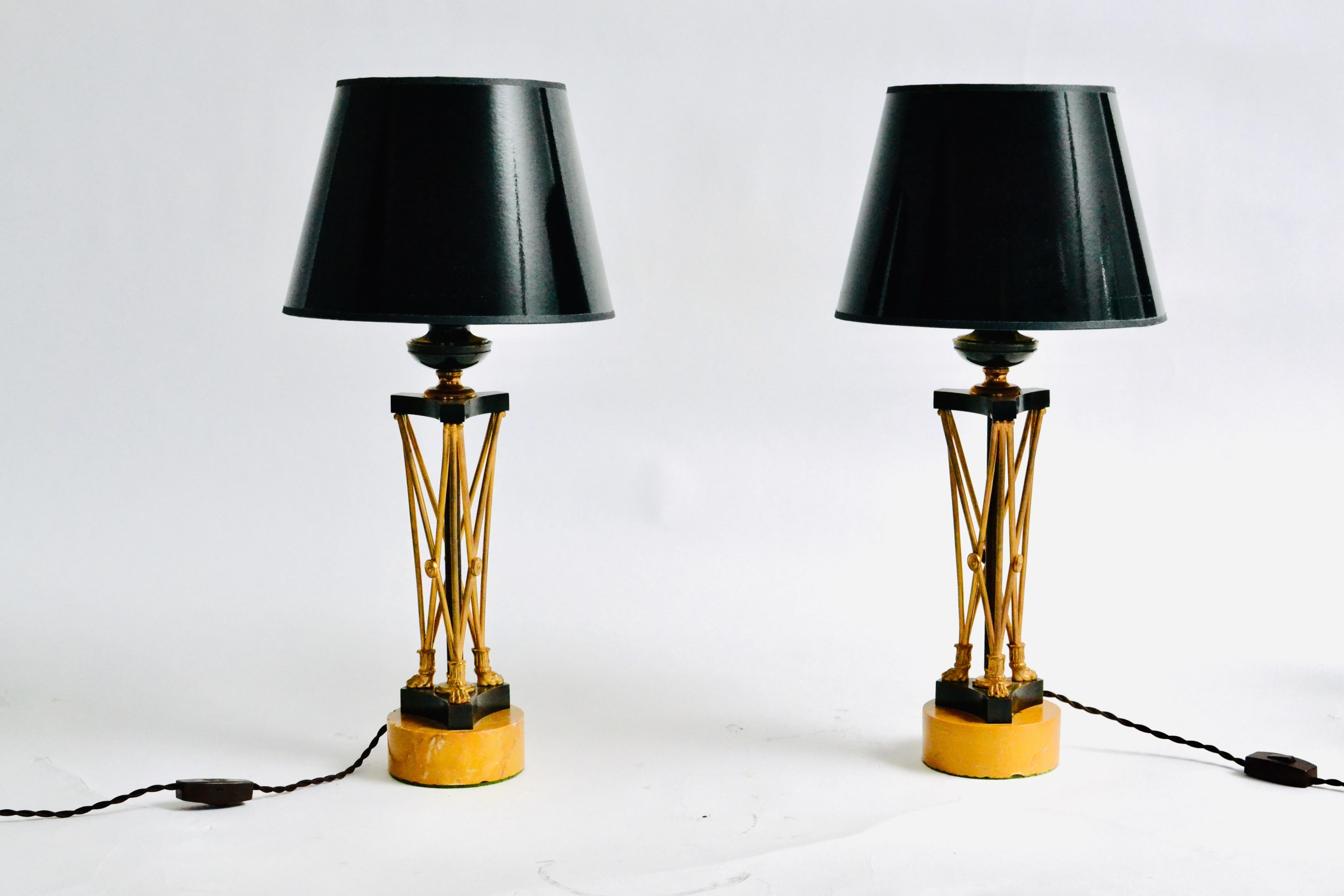 A pair of Regency gilt and patinated bronze candlesticks now mounted as lamps on circular Siena marble bases, early 19th century. Unusual model. 

The Regency era of British history officially spanned the years 1811-1820, though the term is commonly