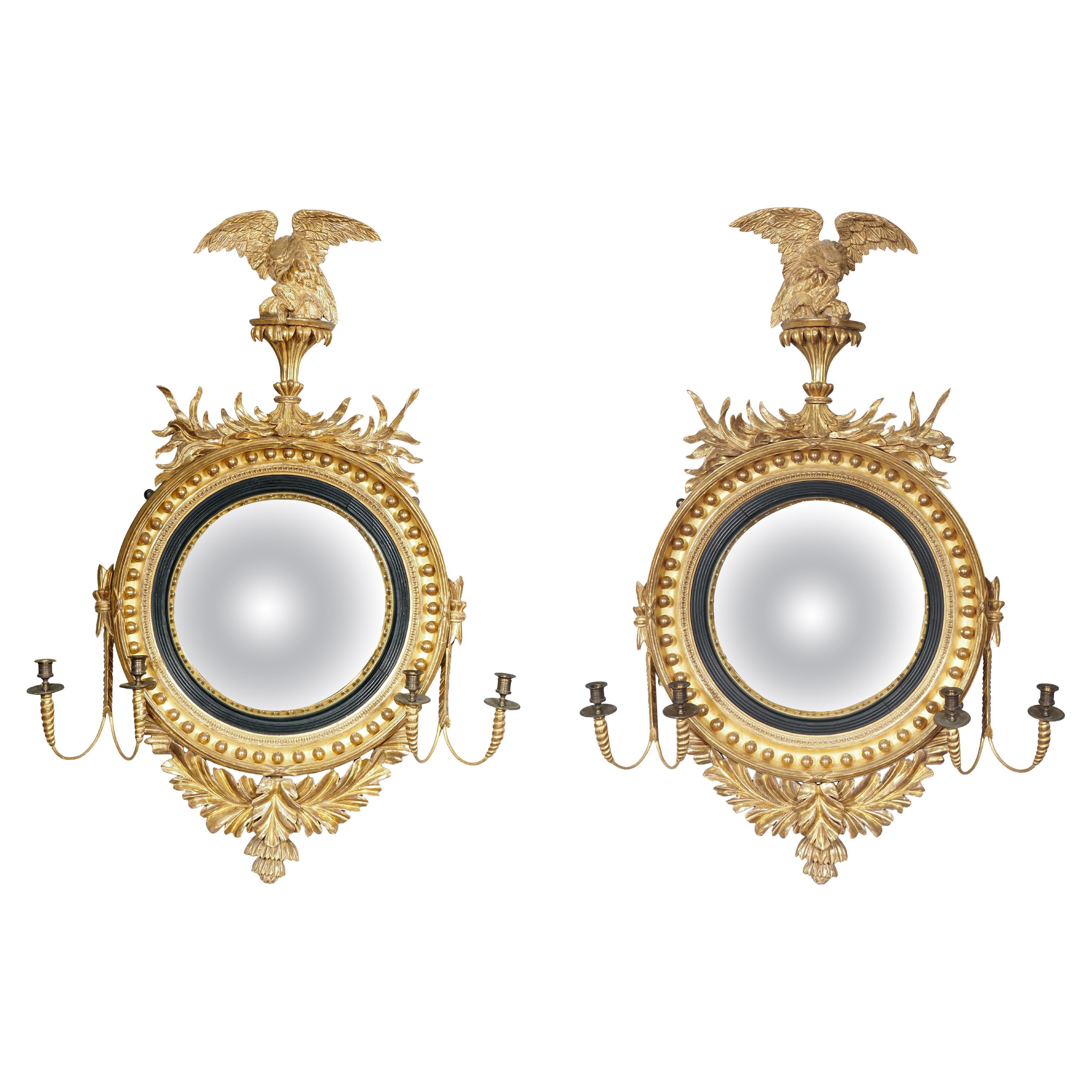 Coppia di specchi Girandole Convex Regency in legno dorato ed ebanizzato in vendita