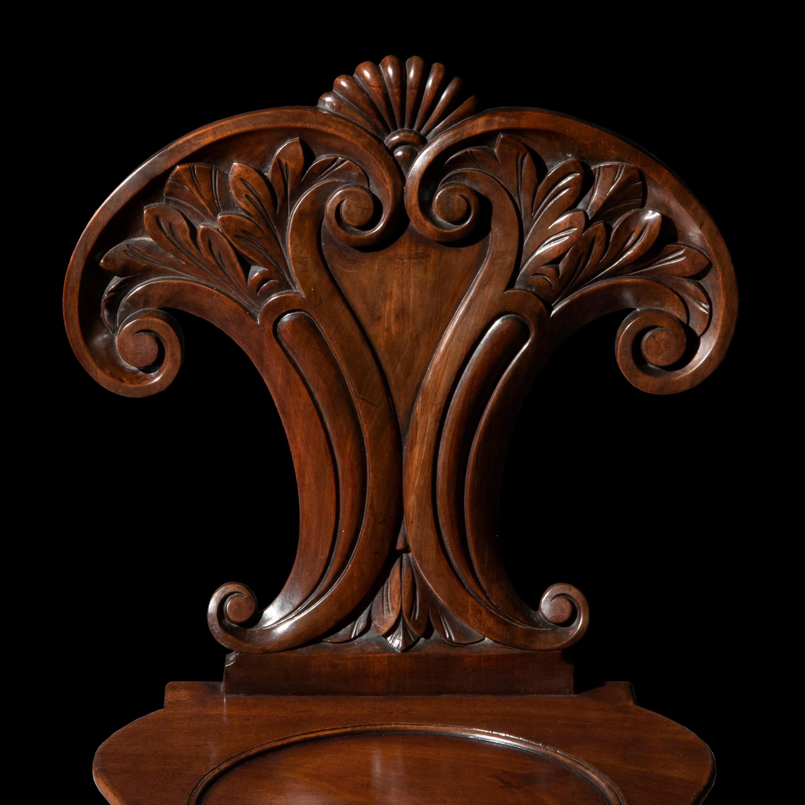 An unusually sculptural pair of Regency period hall chairs attributable to Gillows of Lancaster and London.
England, circa 1815.

Why we like them
Superb quality, bold, unusual design of elaborate shapes, informed by Roman antiquity. Wonderfully