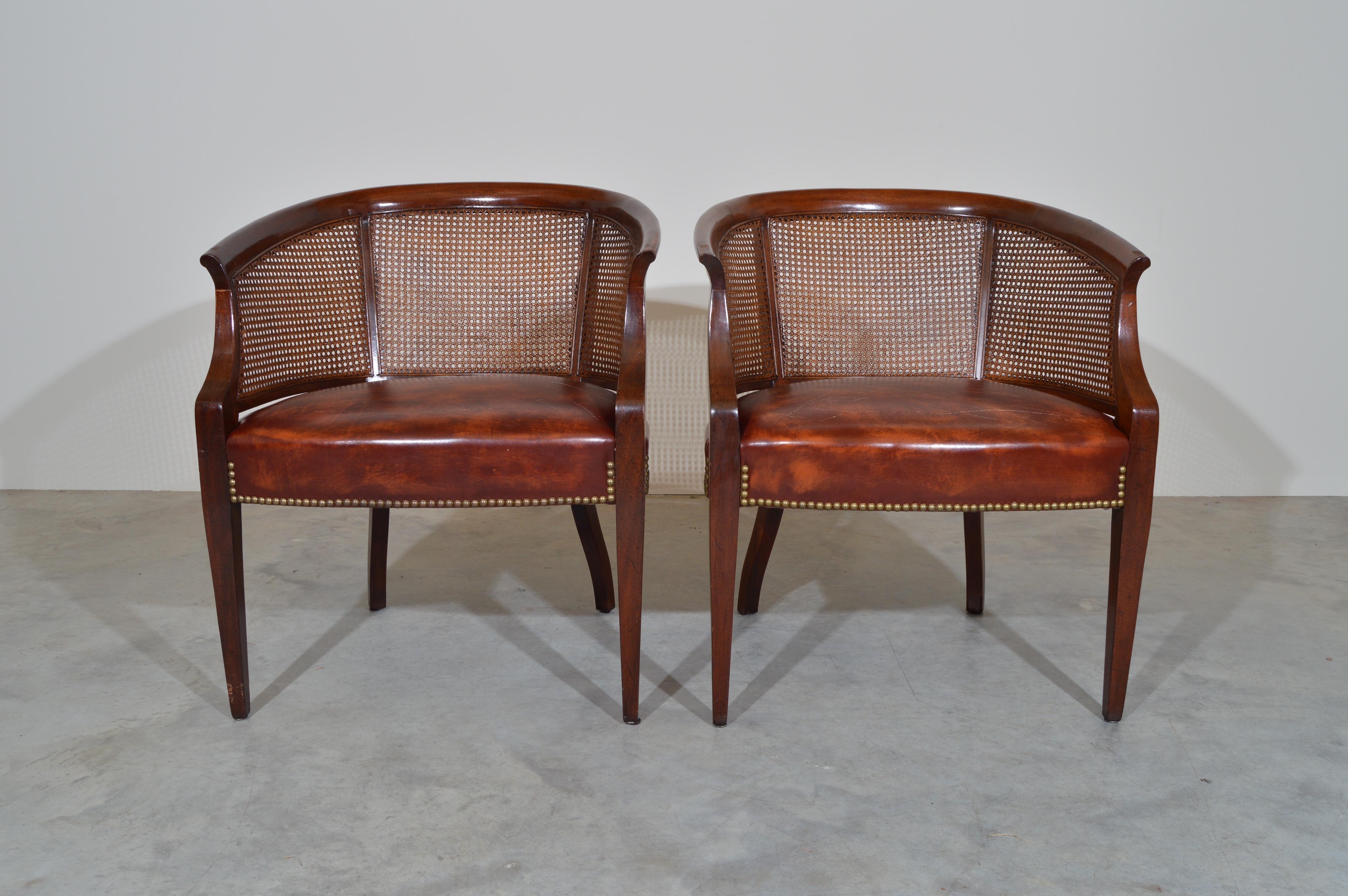 A beautiful matched pair of cane barrel back club chairs with lithe front legs by Hickory Chair Co. with an incredibly convincing original faux leather. 1974 production. 
Beautiful, clean condition. 
We have 2 identical pairs available.
