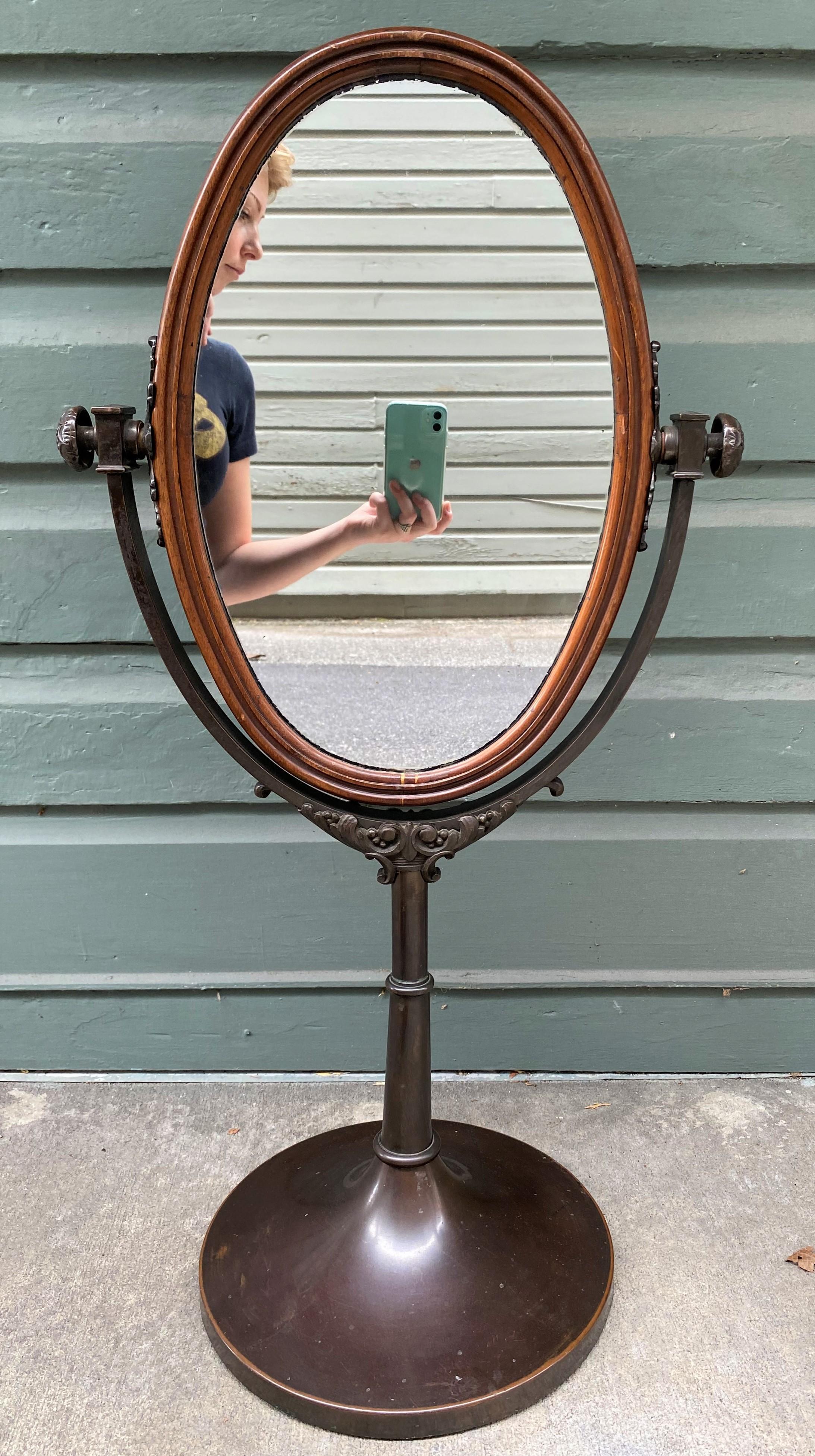 Wonderful mid-19th century pair of table top English Regency dressing mirrors. The mirrors are framed in mahogany and both sides are mirrored. The stands are made of bronze. The mirrors measure 12.25