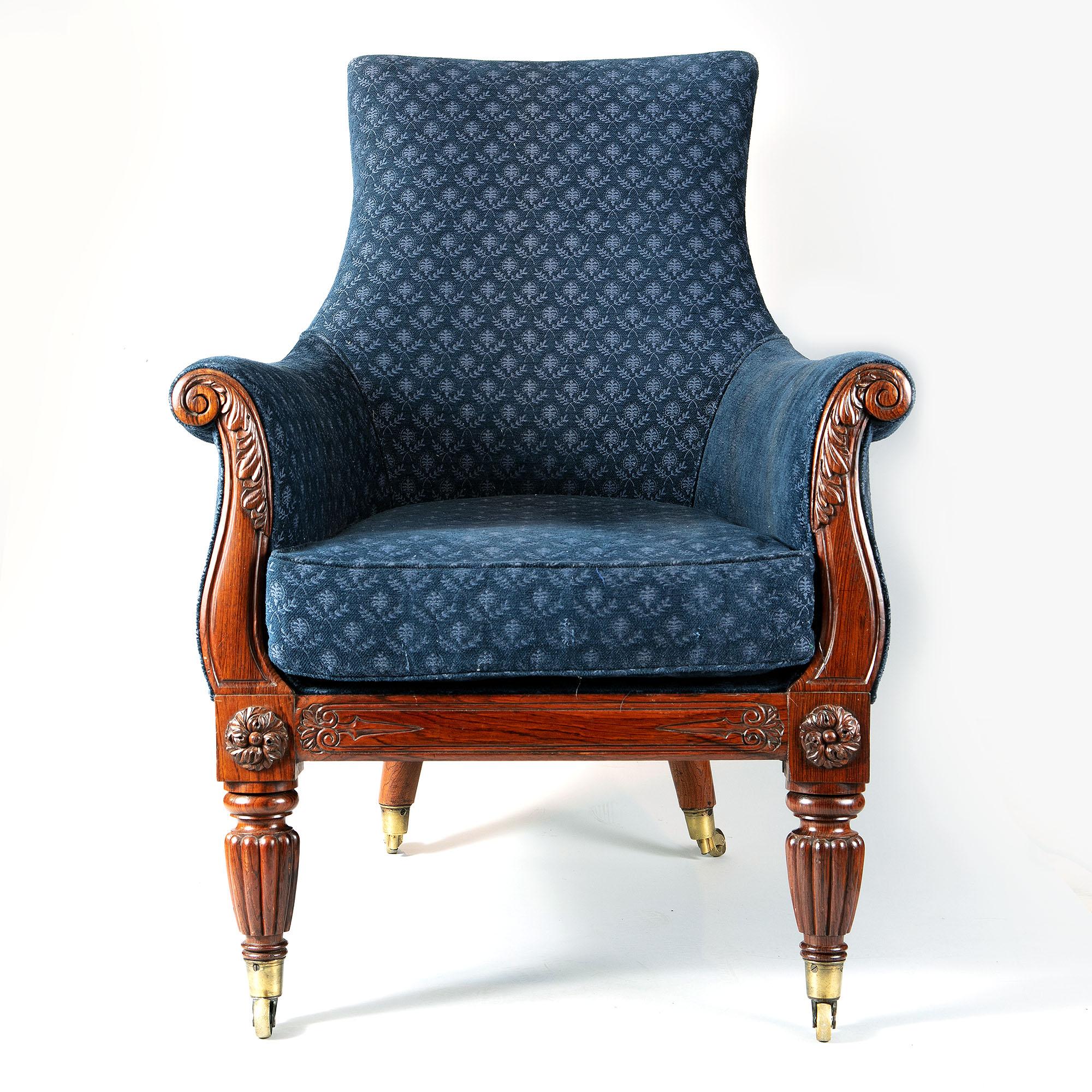 A very good pair of Regency rosewood lyre-shaped library armchairs. Upholstered in figured blue material with loose squab seat cushions, the chairs have tall shaped and curved backs with outswept lyre-shaped arms having acanthus carved scrolling