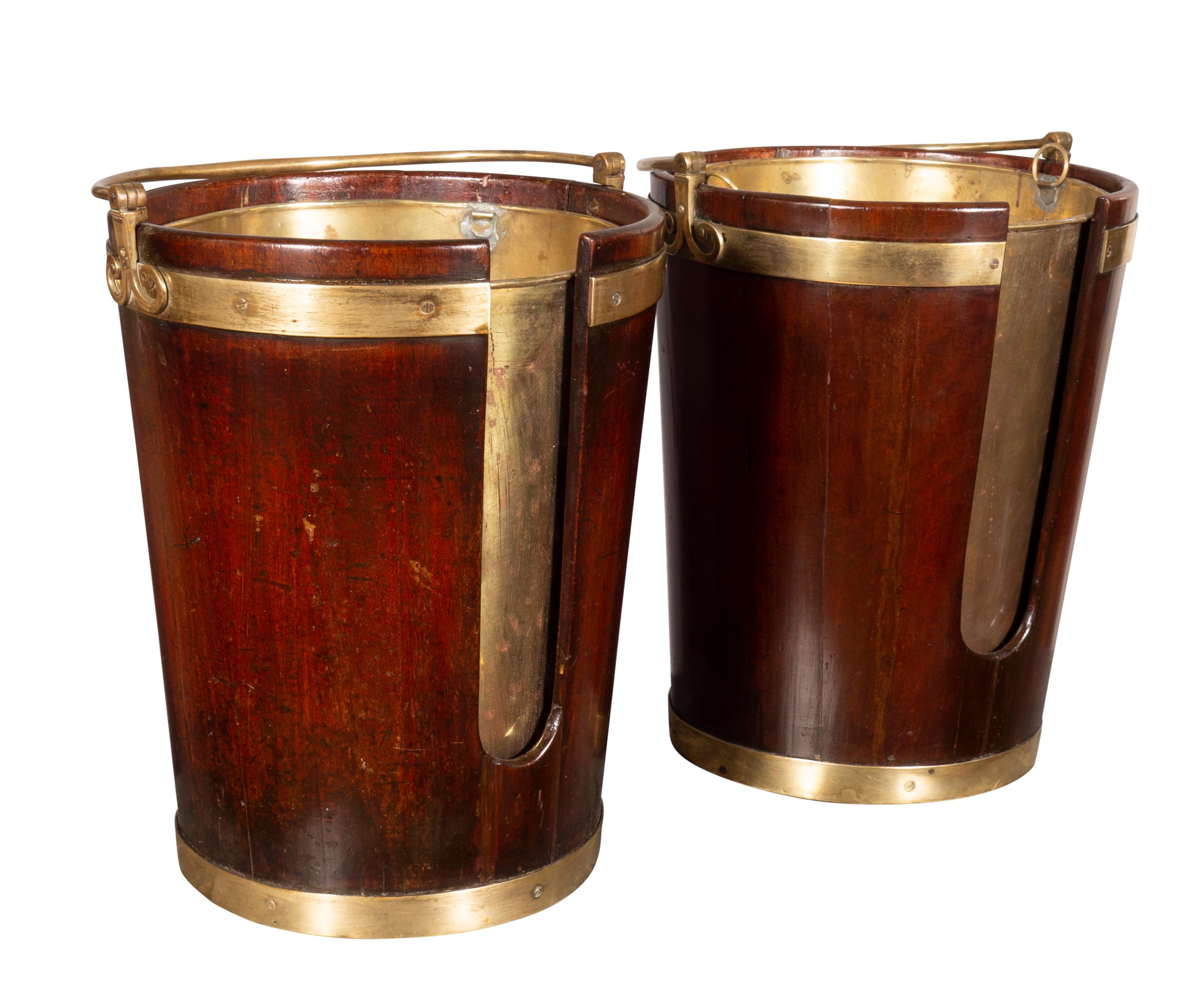 Now with brass liners. Typical form with brass bail handle tapered cylindrical form with brass banding.