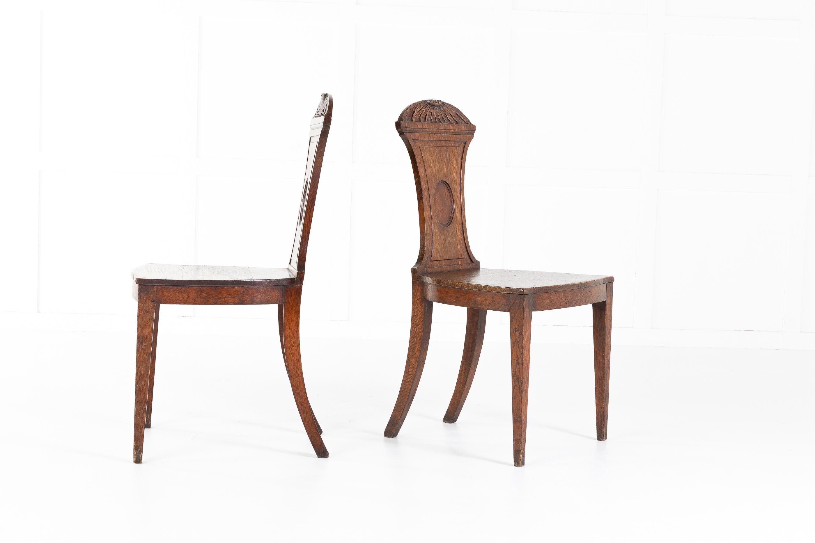 Pair of 19th century Regency oak hall chairs with carved backs. Solid seats upon elegant, tapered legs with outswept back legs.
Measures: Seat height 43cm
Seat depth 39.5cm.