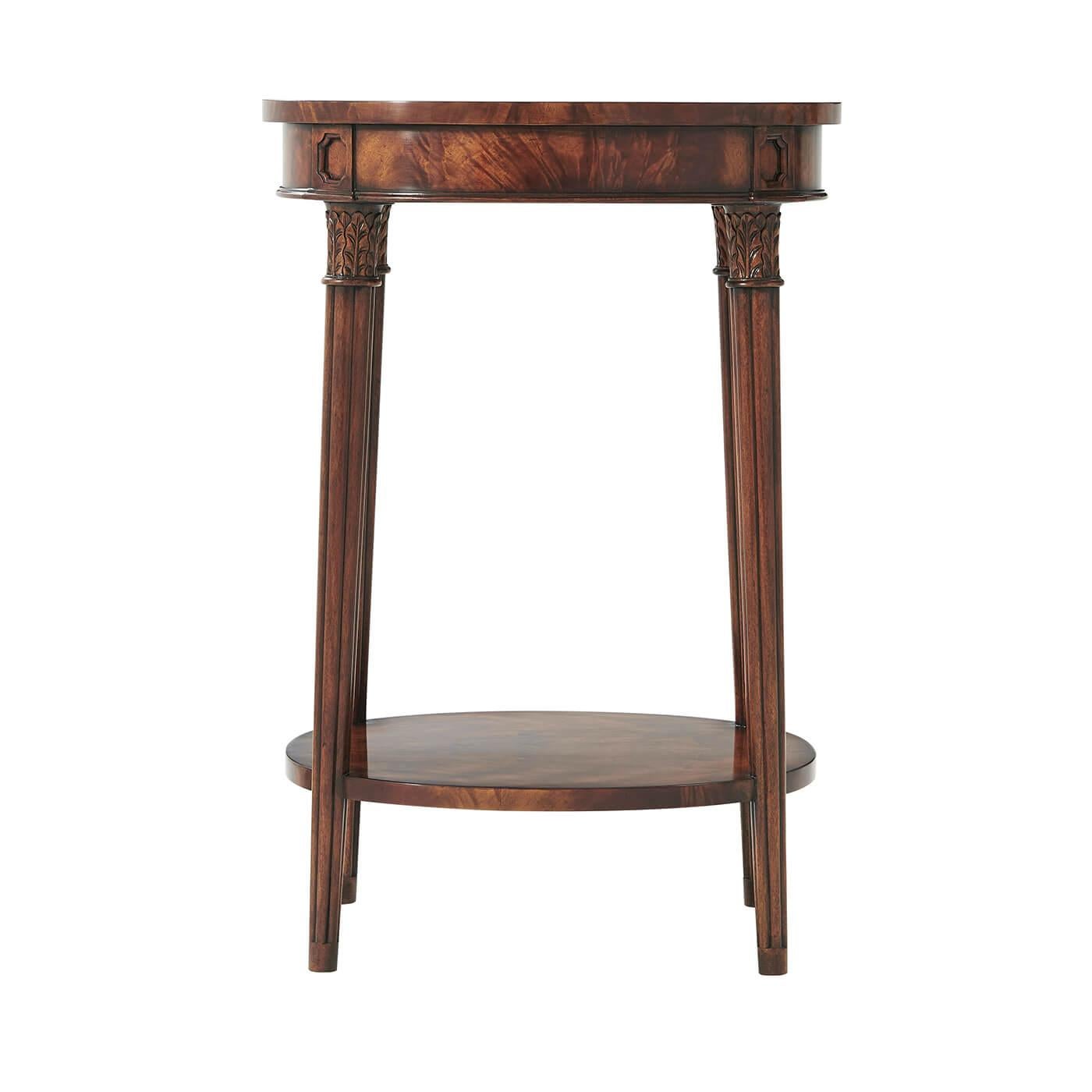 A Regency style flame veneered and mahogany lamp table, the oval top on gently splayed acanthus capital and reeded tapering legs joined by an under tier.
Dimensions: 20