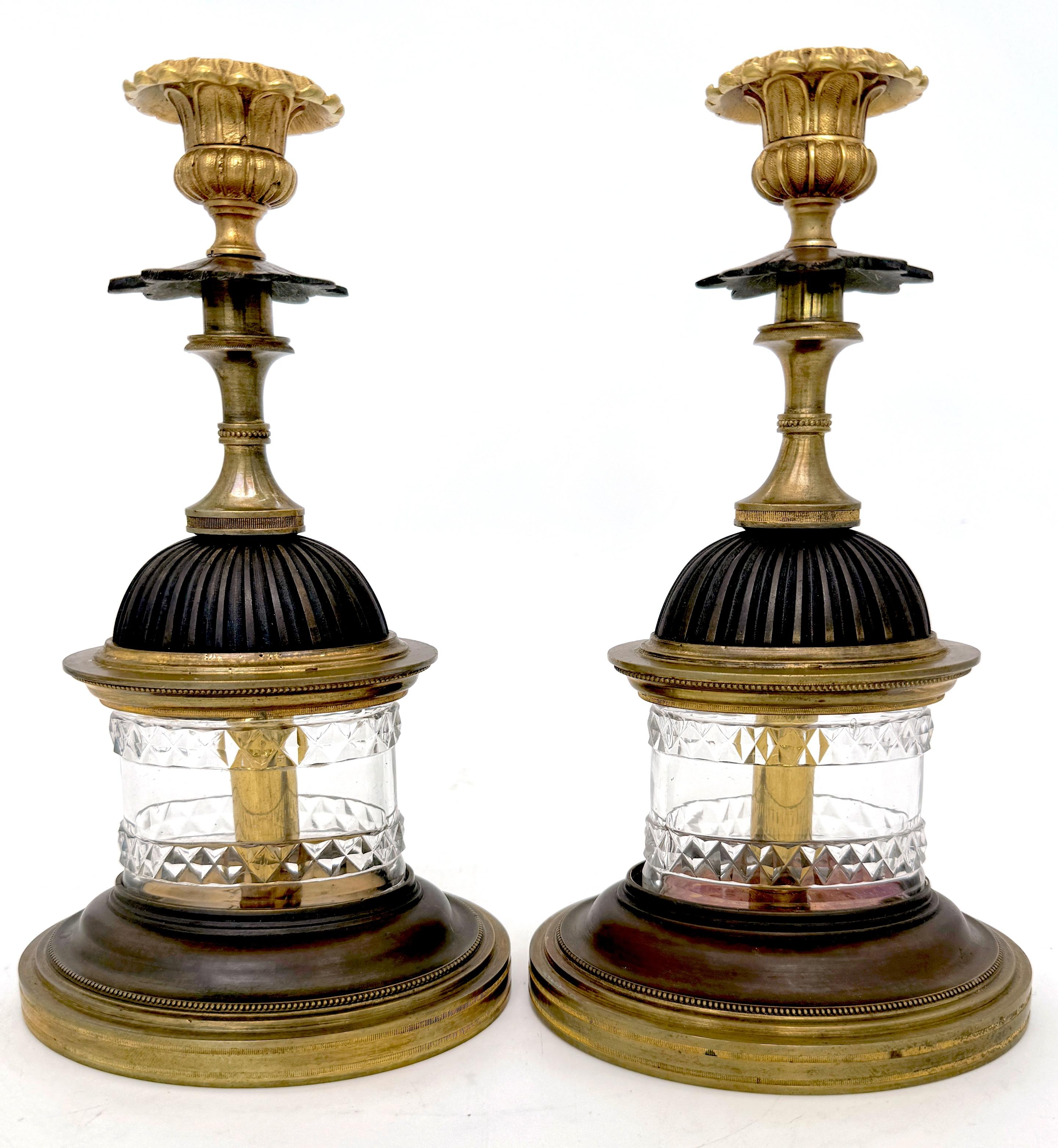 Pair of Regency Pagoda-Cut Glass Gilt and Patinated Candlesticks
England, circa 1820

A striking pair of Regency pagoda-shaped candlesticks from England, circa 1820. These architectural models stand 10.25 inches high, 5.75 inches wide, and 4.25