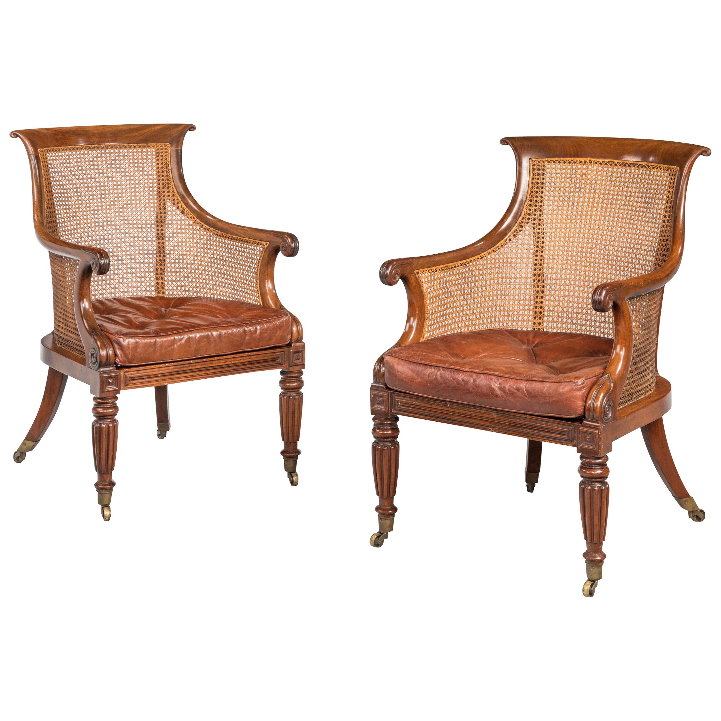 Pair of Regency Period Bergere Library Chairs with Swept Arms