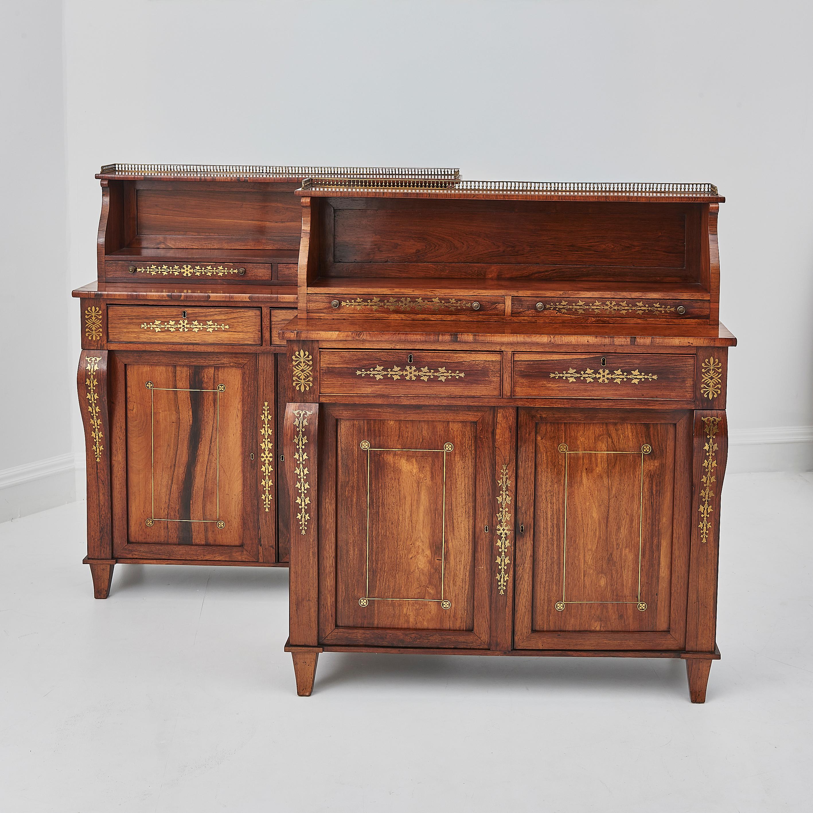 An exquisite pair of 19th Century rosewood &  brass inlaid chiffoniers. These rare and beautifully presenting Chiffoniers feature a brass pierced gallery top,  with finely detailed floral brass inlay throughout flanked by scrolling volutes. 

The