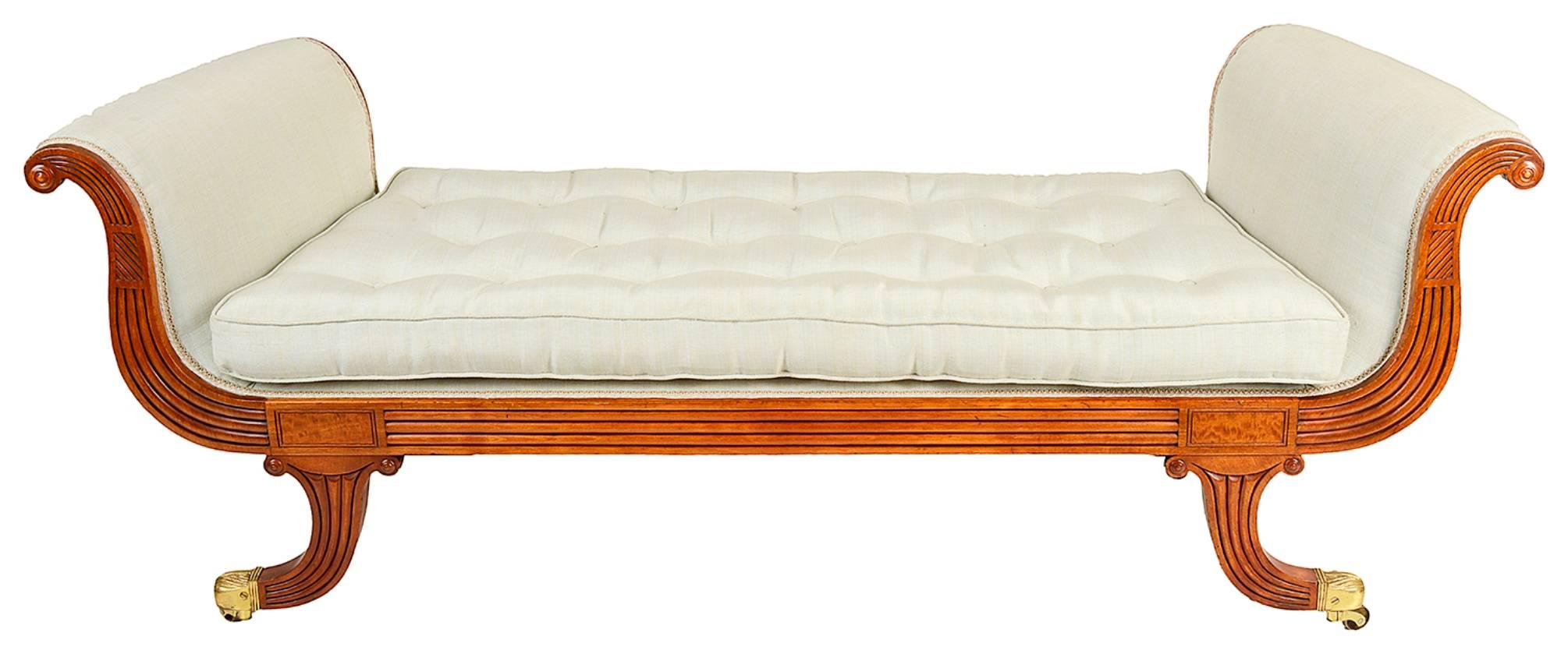 A good quality Regency period Mahogany 'Gillows influenced ' window seat. Each having reeded decoration to the fronts, stuff-over upholstery, raised on out swept feet, terminating in the original brass castors.