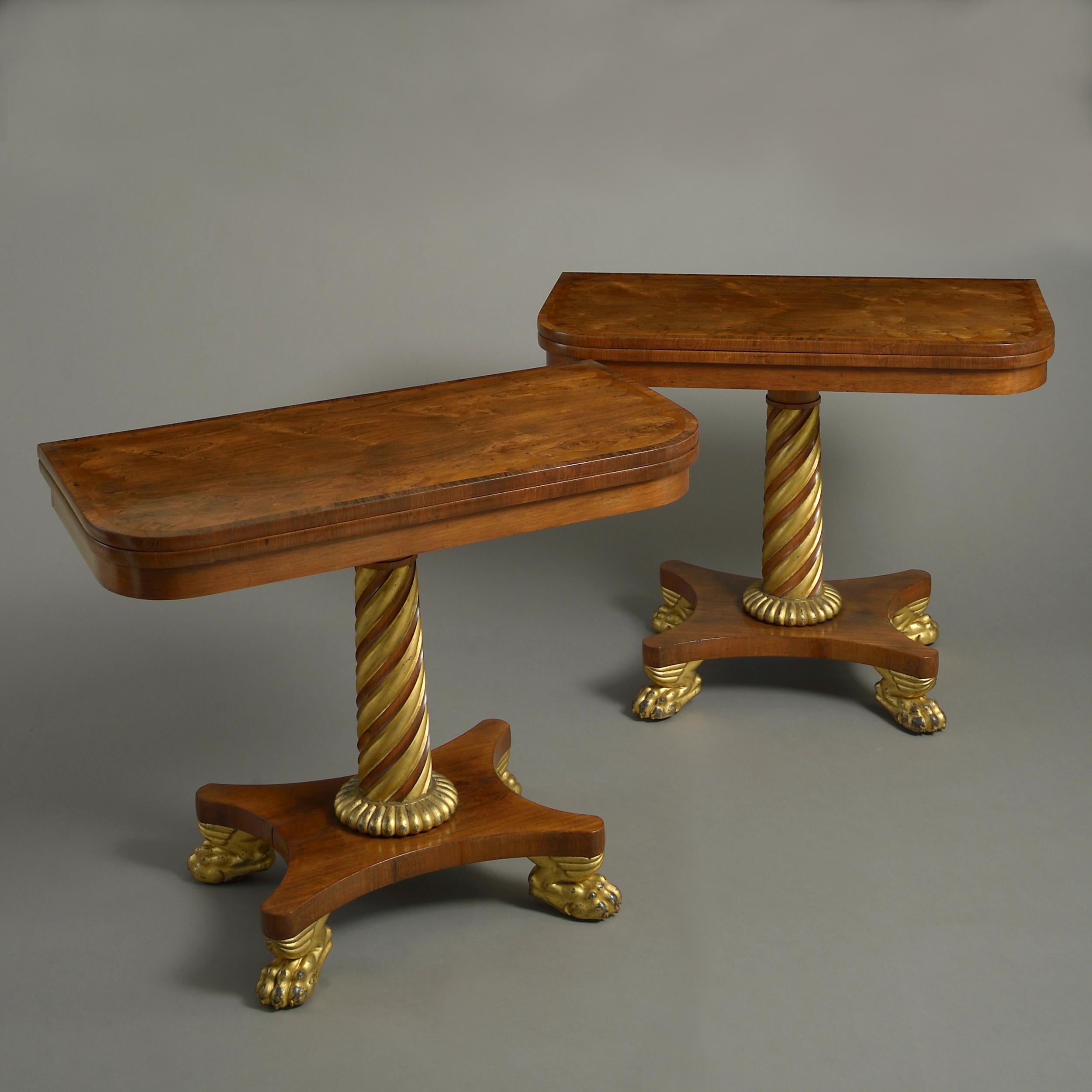 A fine pair of Regency rosewood and parcel-gilt card tables, circa 1820.

Each with a swiveling fold-over top, inlaid in yew-wood with a pattern of gothic arcading. The interiors lined in red baize.