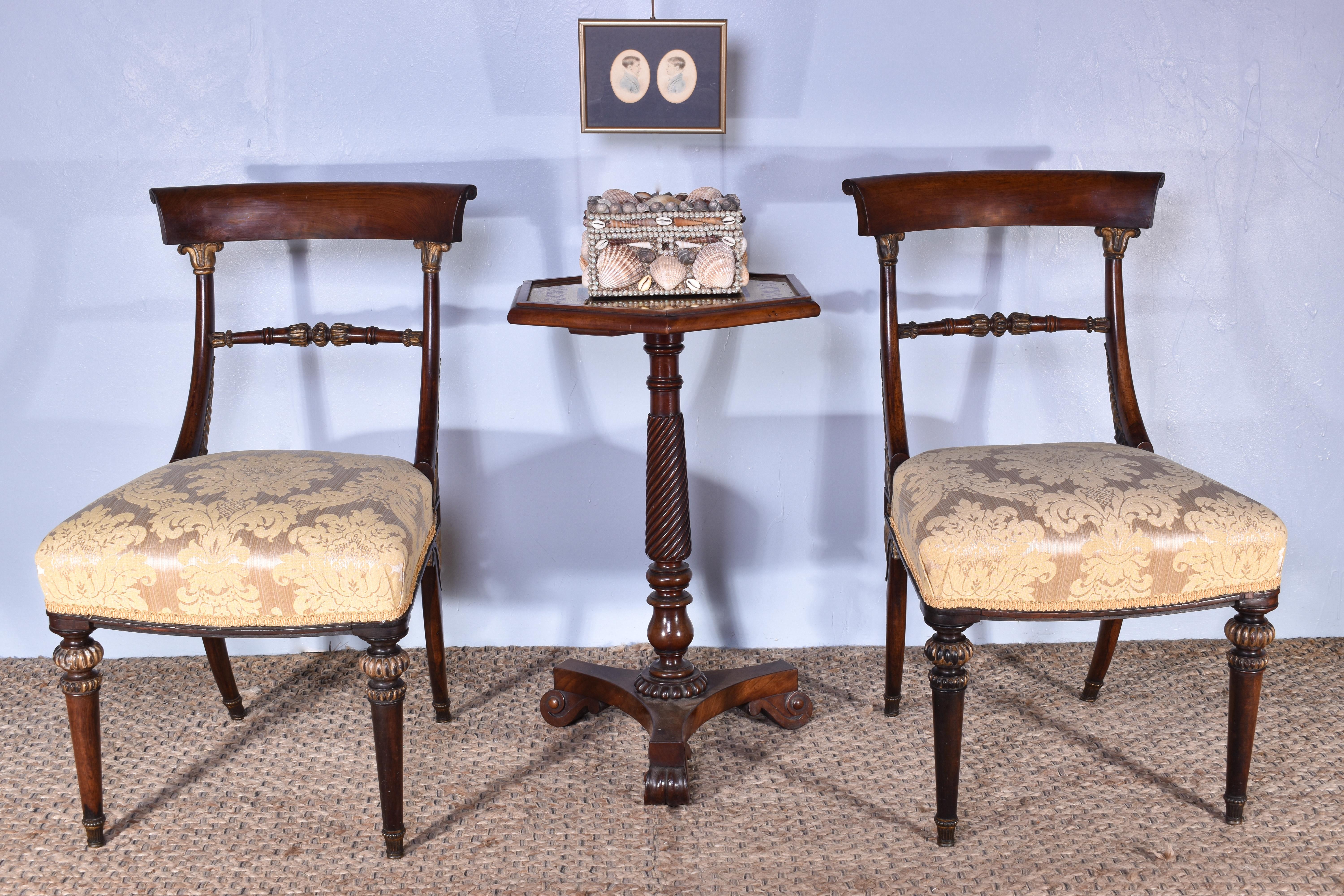 A fabulous pair of late regency period rosewood with parcel gilt side chairs, attributed to Morel & Hughes C.1820

Of the highest quality and in the typical high style of the period.

With traditionally upholstered seats, covered in a golden silk