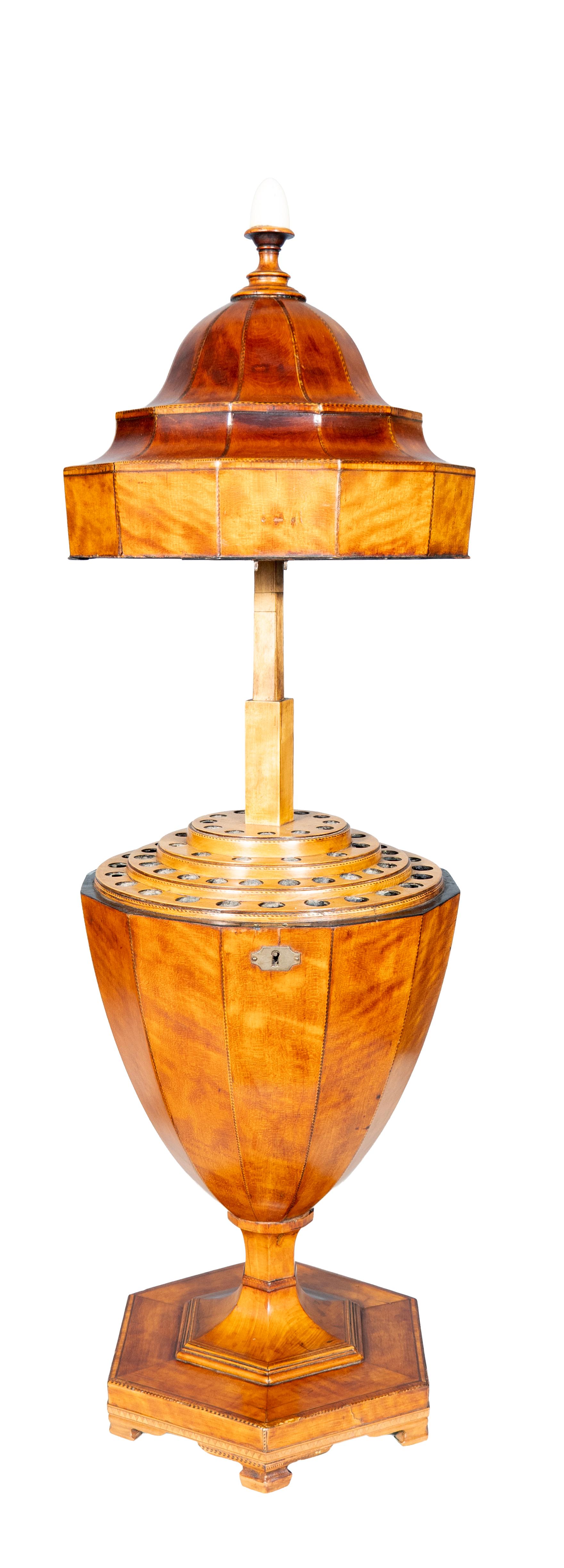 Elegant urn form with ratcheted lift locking cover exposing fittings for cutlery. In fine satinwood originally placed on a sideboard or pedestals next to a sideboard. Bracket feet. No keys.