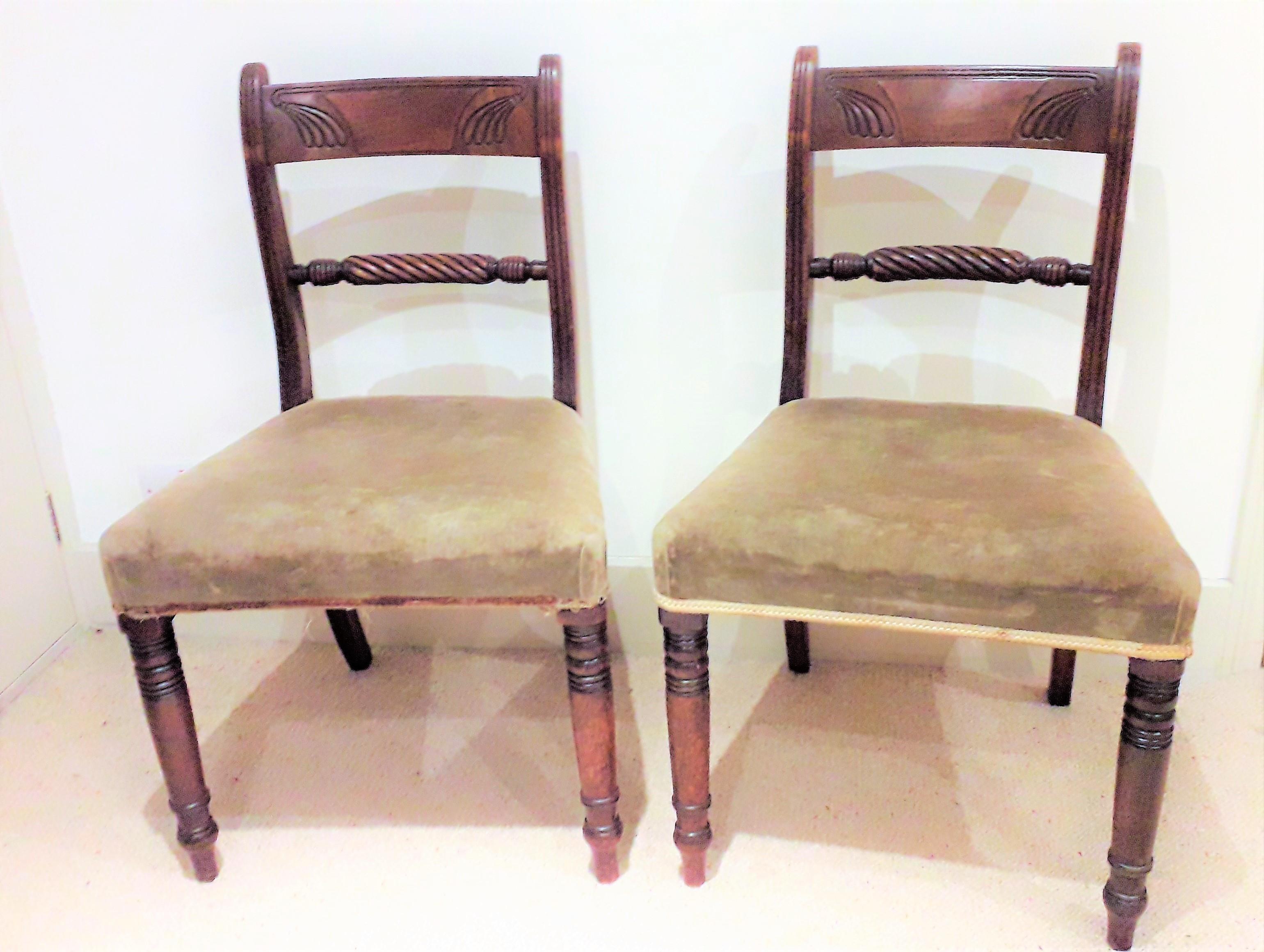 Pair of Regency side chairs in mahogany with original soft patination, the carved back and rope twist rails giving extra fine London made detailing, the back legs in out swept style with the fronts legs being ring turned, all in the true Regency