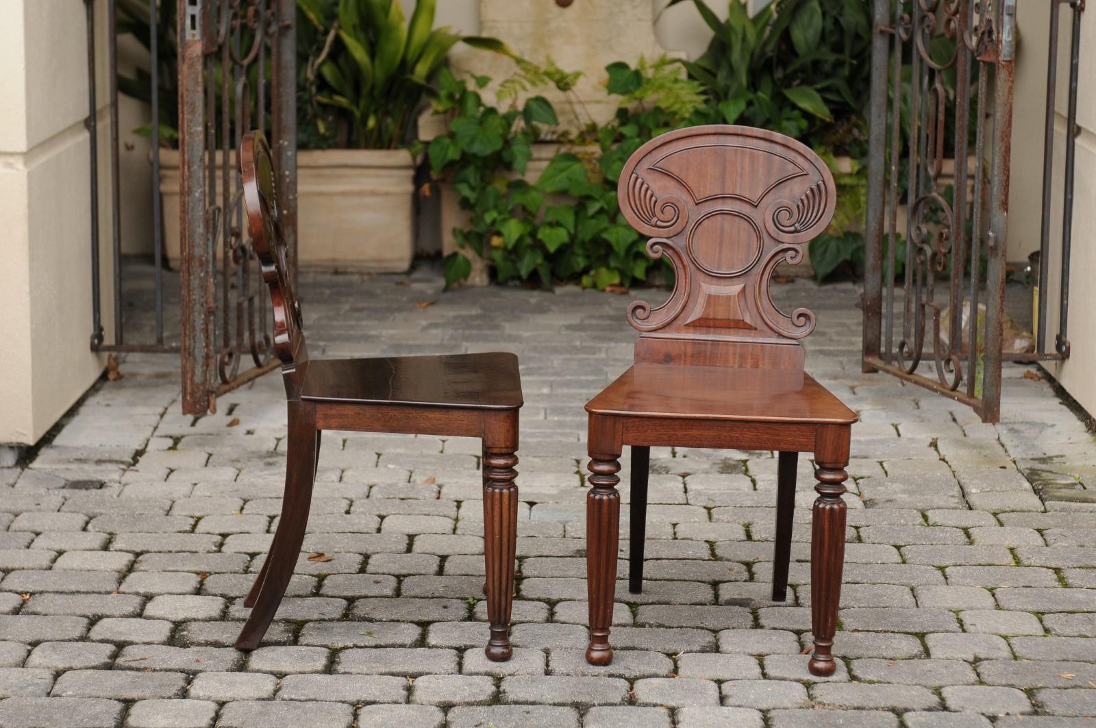 Pair of Regency Style 1870s Carved Mahogany Hall Chairs with C-Scroll Backs (Englisch)