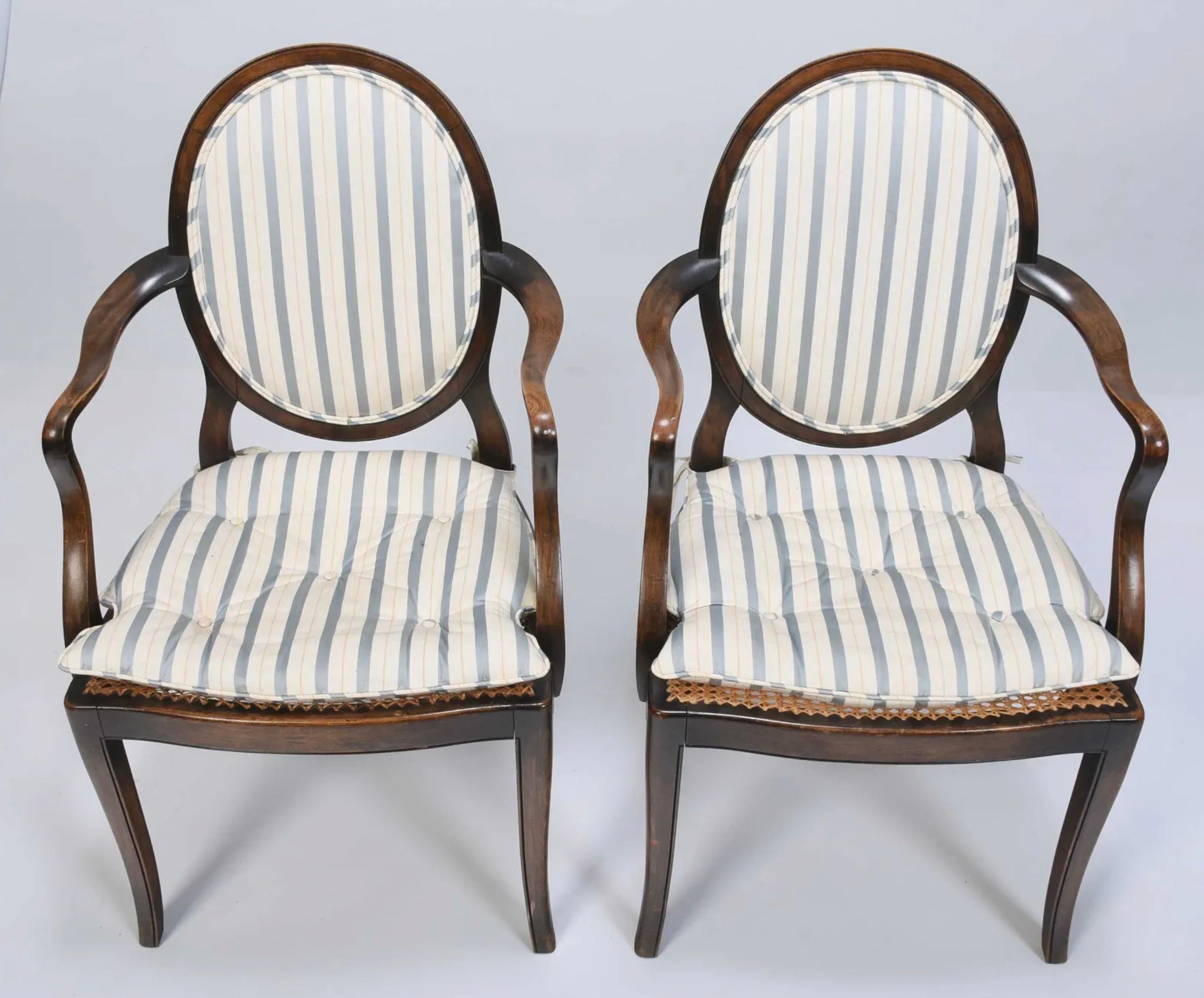 20th century, upholstered oval back, shaped arms, caned seat with loose cushions, tapered legs, 36-1/2 x 21-1/2 x 18 in.

Provenance: Property from the Collection of Ambassador Bonnie McElveen-Hunter