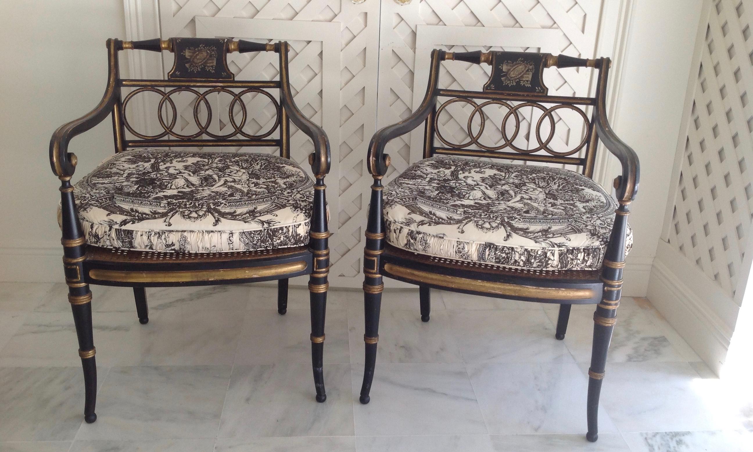 Classic black with gilt appointments. The chairs are fashioned with caned seats and topped
with loose fitted toile appointed cushions. The cushions are 4