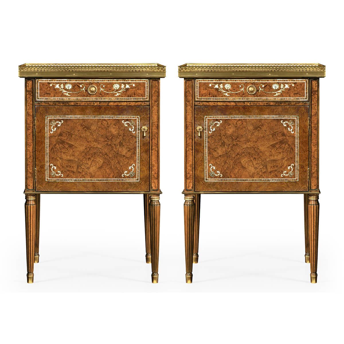 A pair of English Regency style bedside tables with burl veneers, mother of pearl inlays, a pierced brass gallery, each table with a single drawer above a cupboard door, with oak secondary woods, and raised on turned, reeded, and tapered