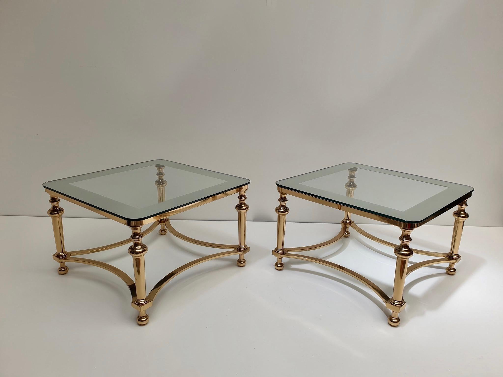 Stunning pair of Hollywood Regency side tables. 
The tables are just stunning and elegant, the tops are made of glass on a brass base. 

Measurements: 40 cm height x 61 cm width.