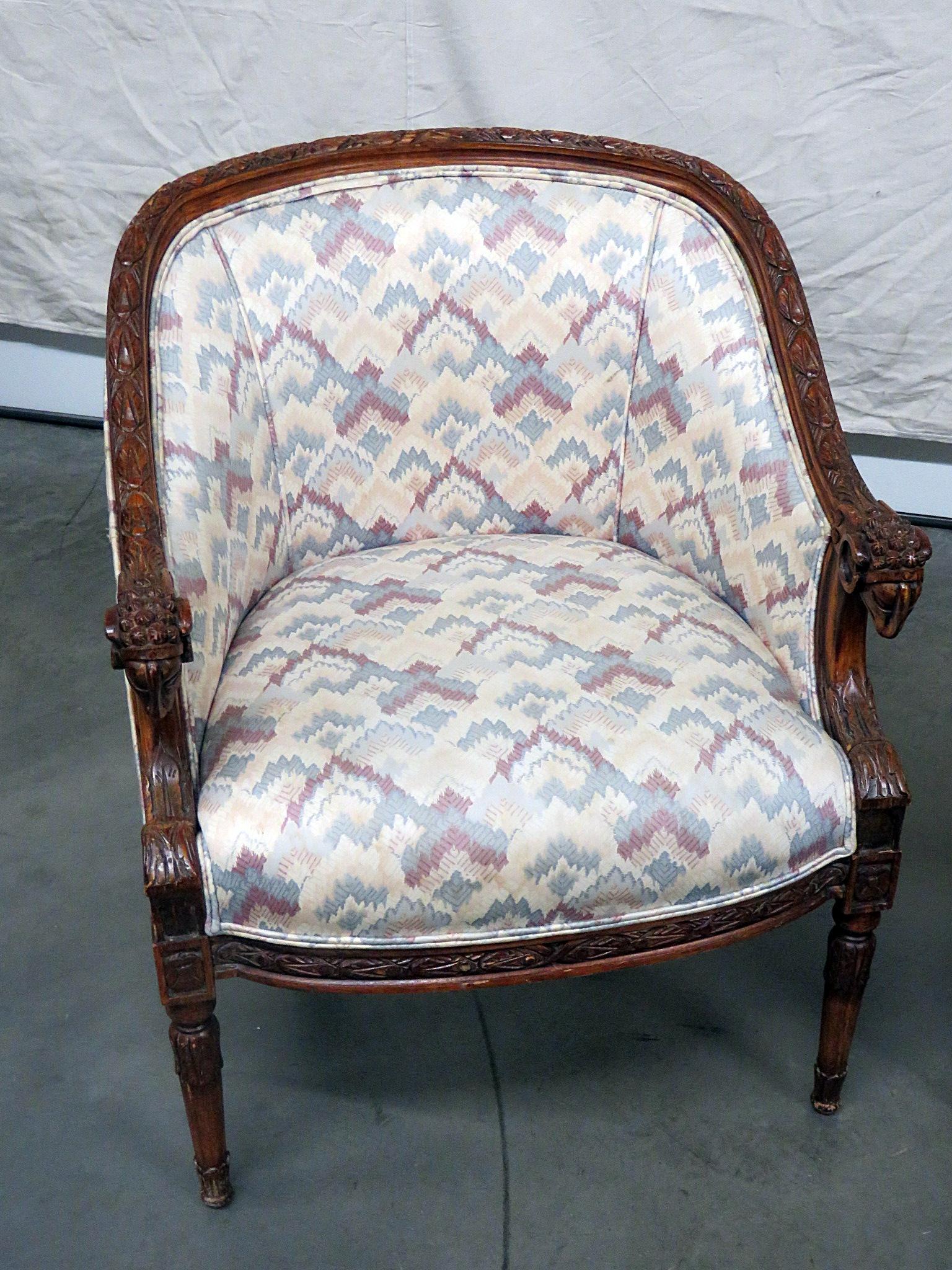 Pair of Regency style club chairs with carved rams heads.