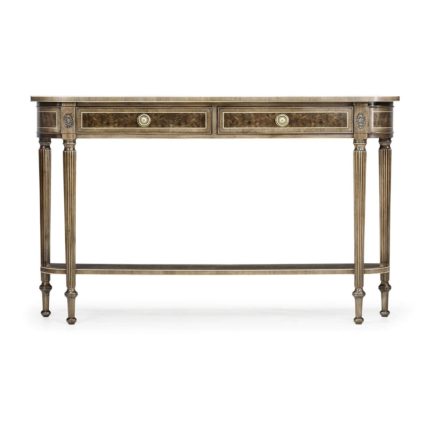 Late Regency style bleached mahogany D form console table with an antiqued finish, two drawers above a shaped under tier set between elegant carved reeded tapering legs topped with paterae.

Dimensions: 54