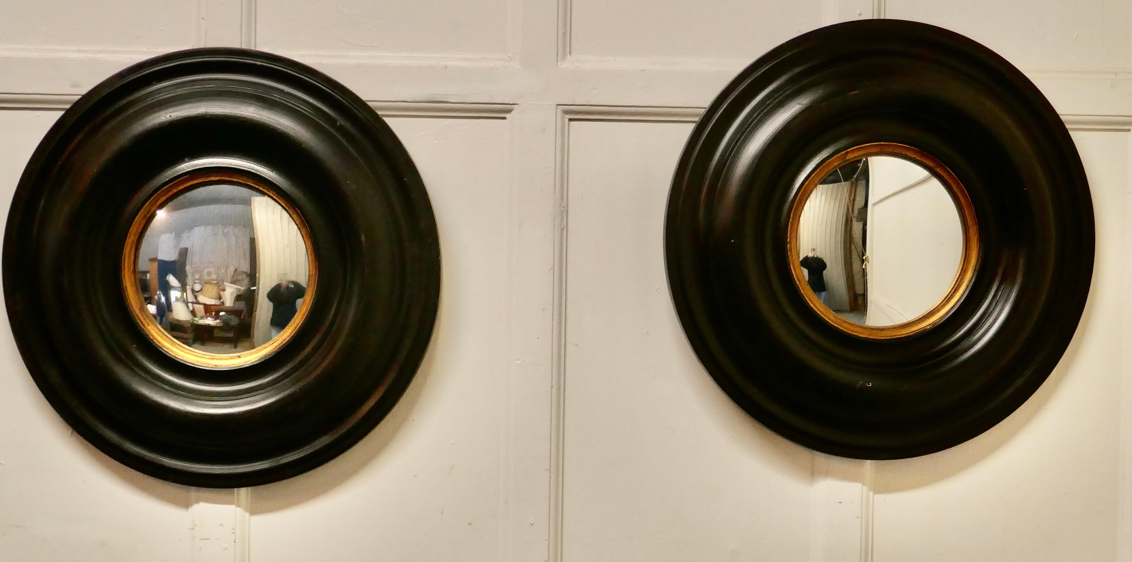 Pair of Regency style ebonised round convex mirrors 

A splendid pair of Large Regency Style Convex Mirrors, the 9” looking glasses are convex, they are set in 8” wide moulded ebonised frames
It is unusual to find a pair this size and they look