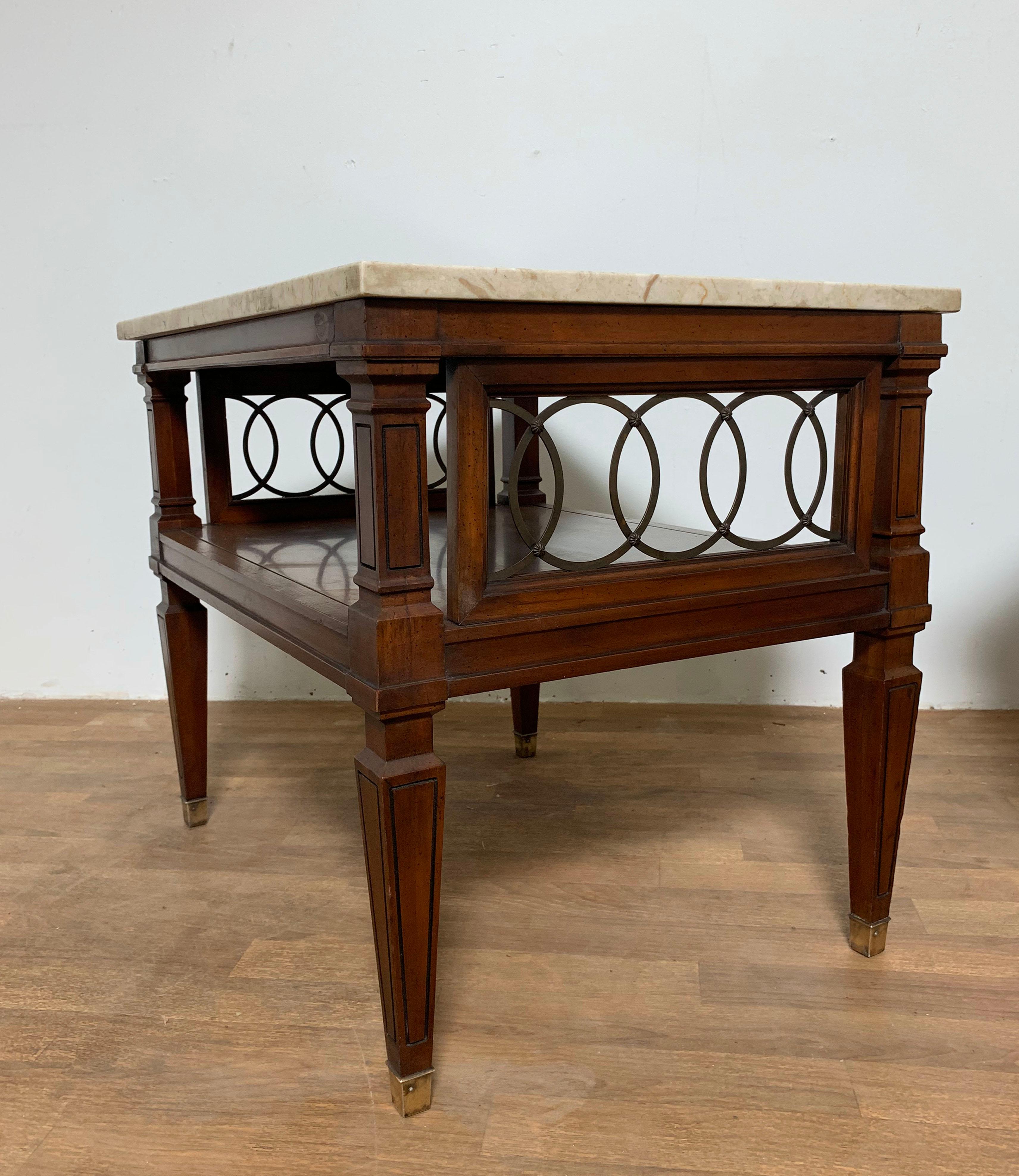 Pair of mid-century end tables in the regency style, with Italian marble tops over open-work wood bases with brass scrollwork.