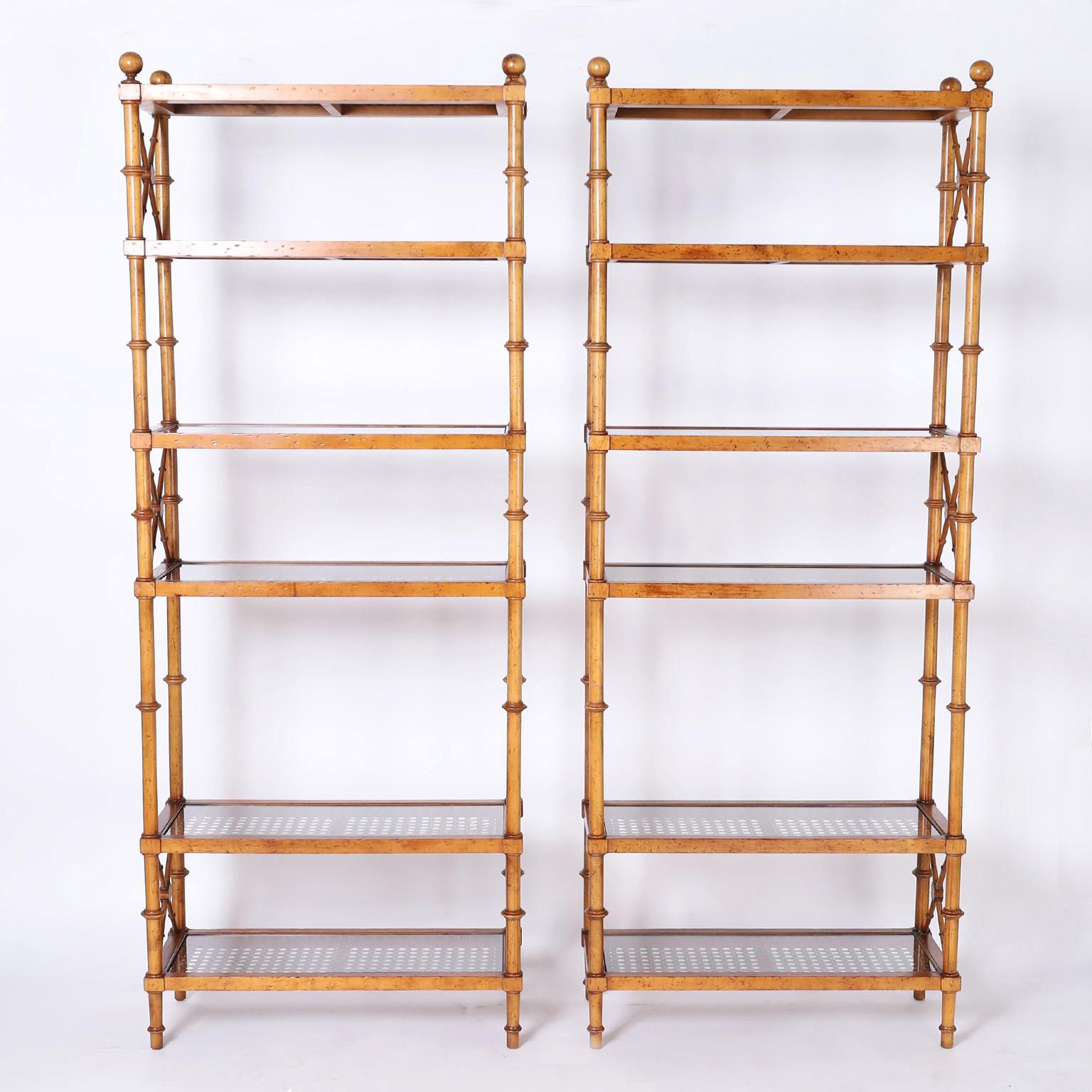 Pair of tall mid century etageres crafted in walnut with a desirable slim profile in classic form with contrived aging. The six shelves are caned under glass.