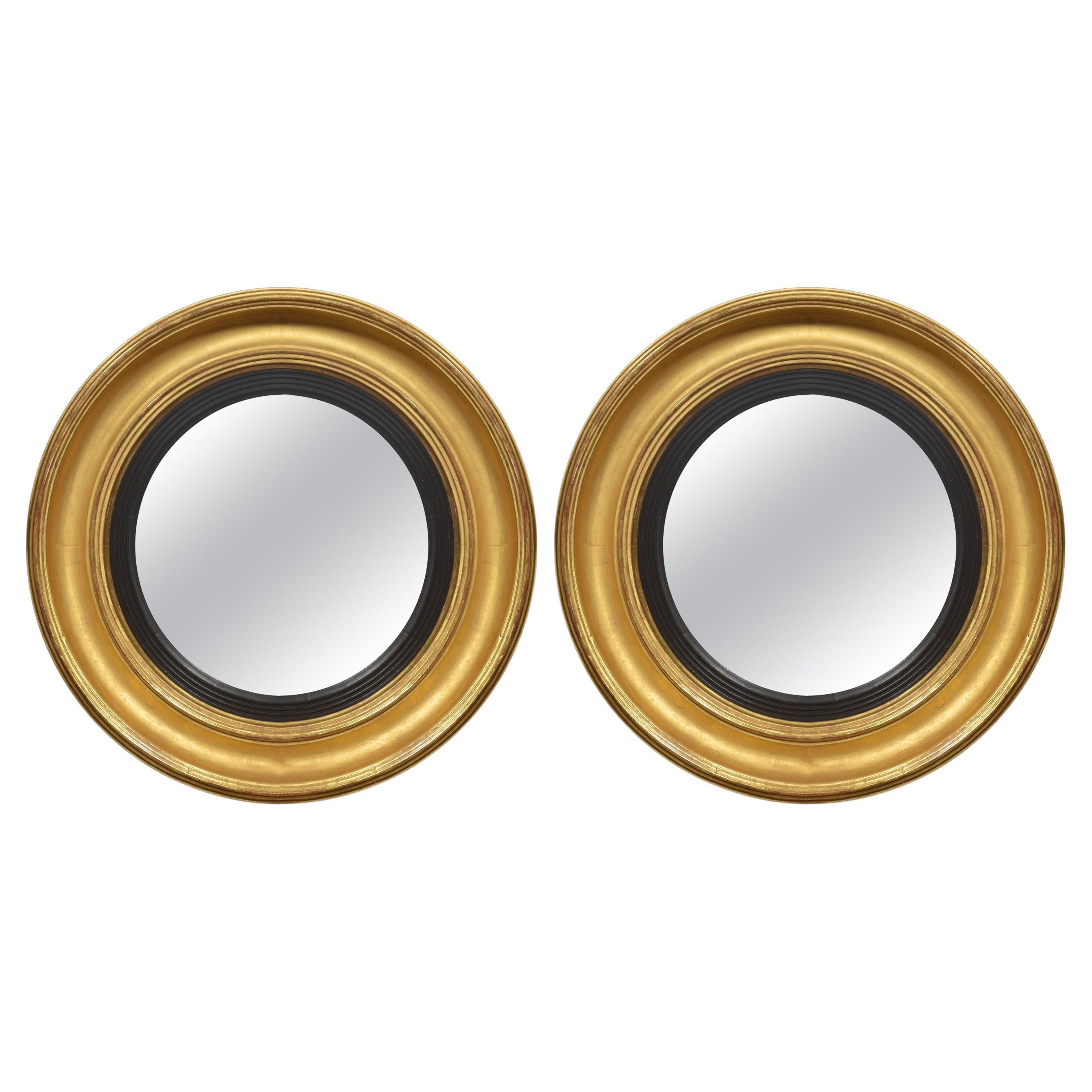 Pair of Regency style gitwood convexed wall mirrors