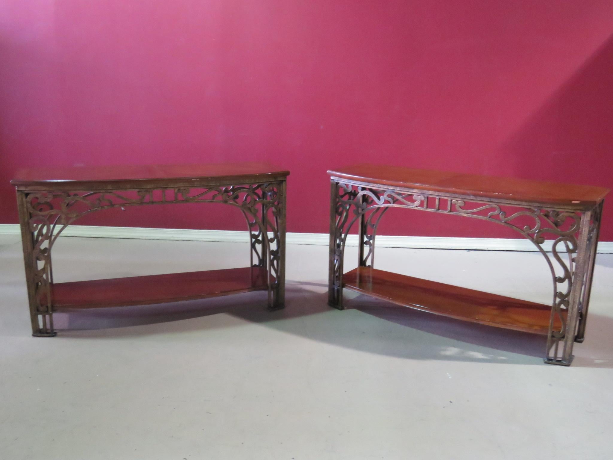 This is a highly ornamental pair of hand-wrought iron console tables with incredible workmanship. They are designed in the style of Louis Majorelle but are not of the period. They are beautifully made and very substantial while remaining visually