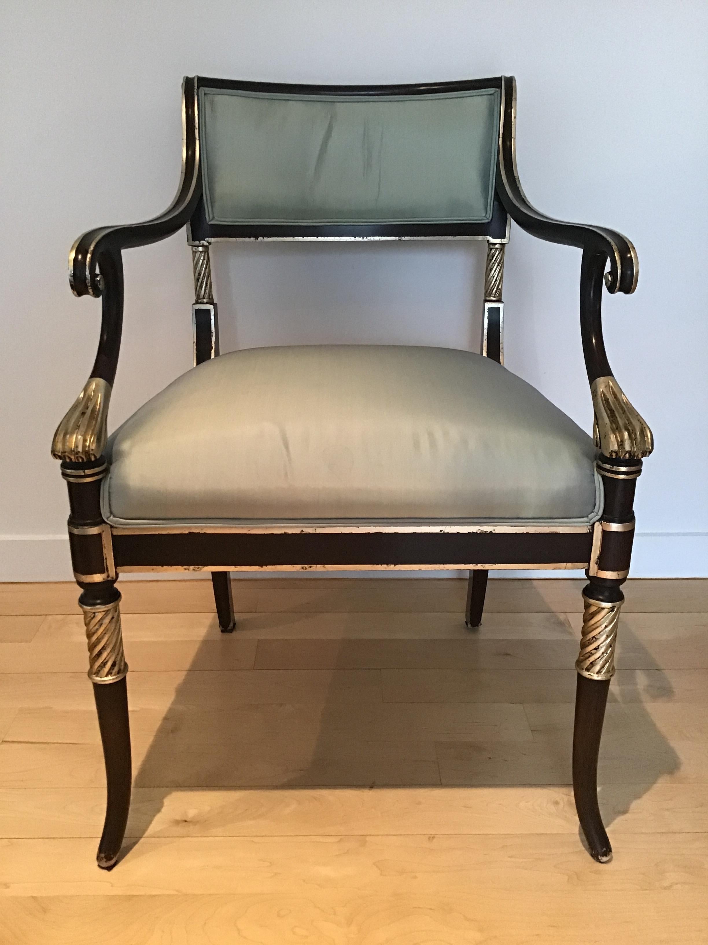 Pair of Regency style Karges armchairs .Silver leaf details. Caned back. Stains on fabric.