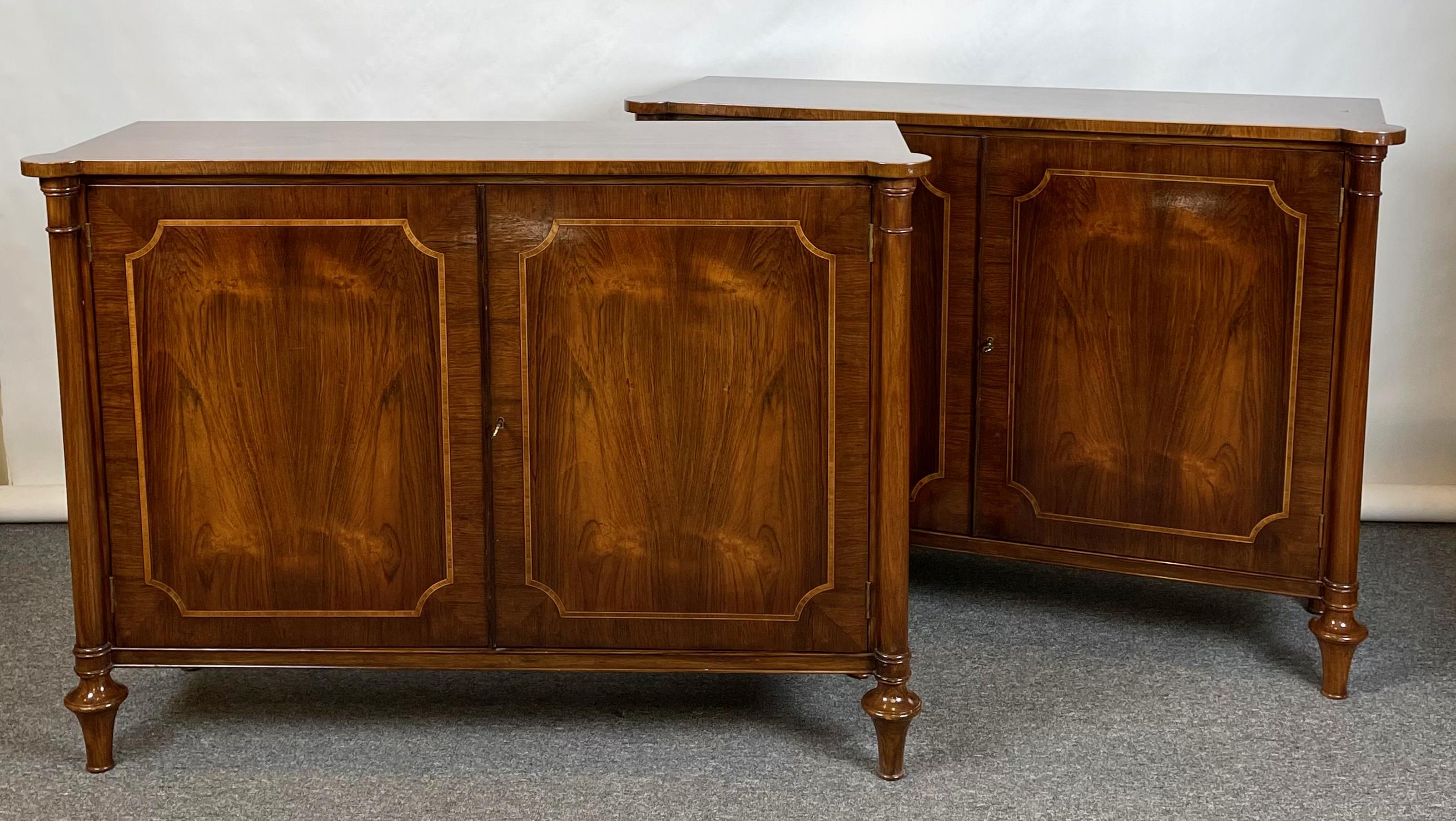 A pair of finely crafted mid-20th C. Regency style rosewood cabinets, each having two doors revealing interior shelves.