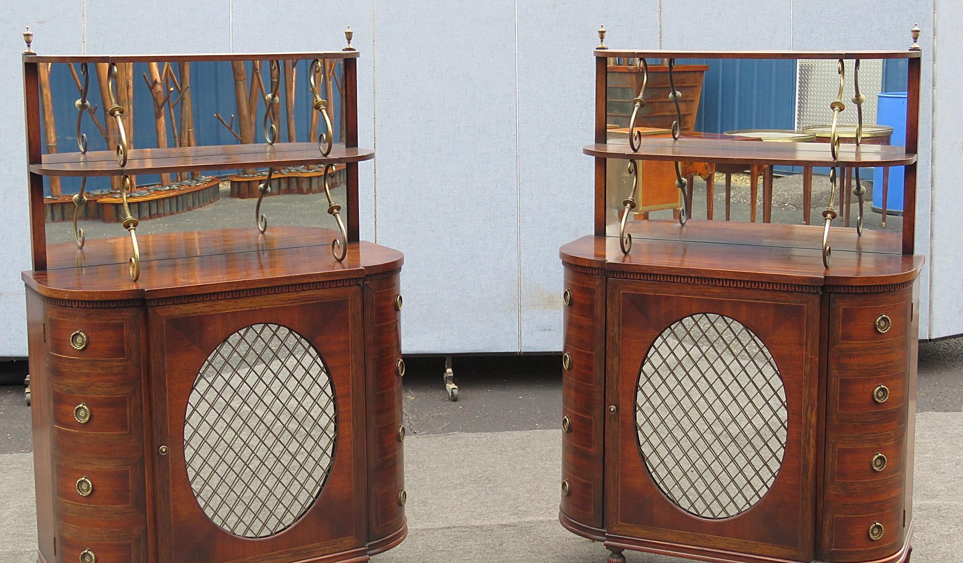 Pair of Regency style servers with two shelves on top with mirrored backs and three doors each containing two shelves.