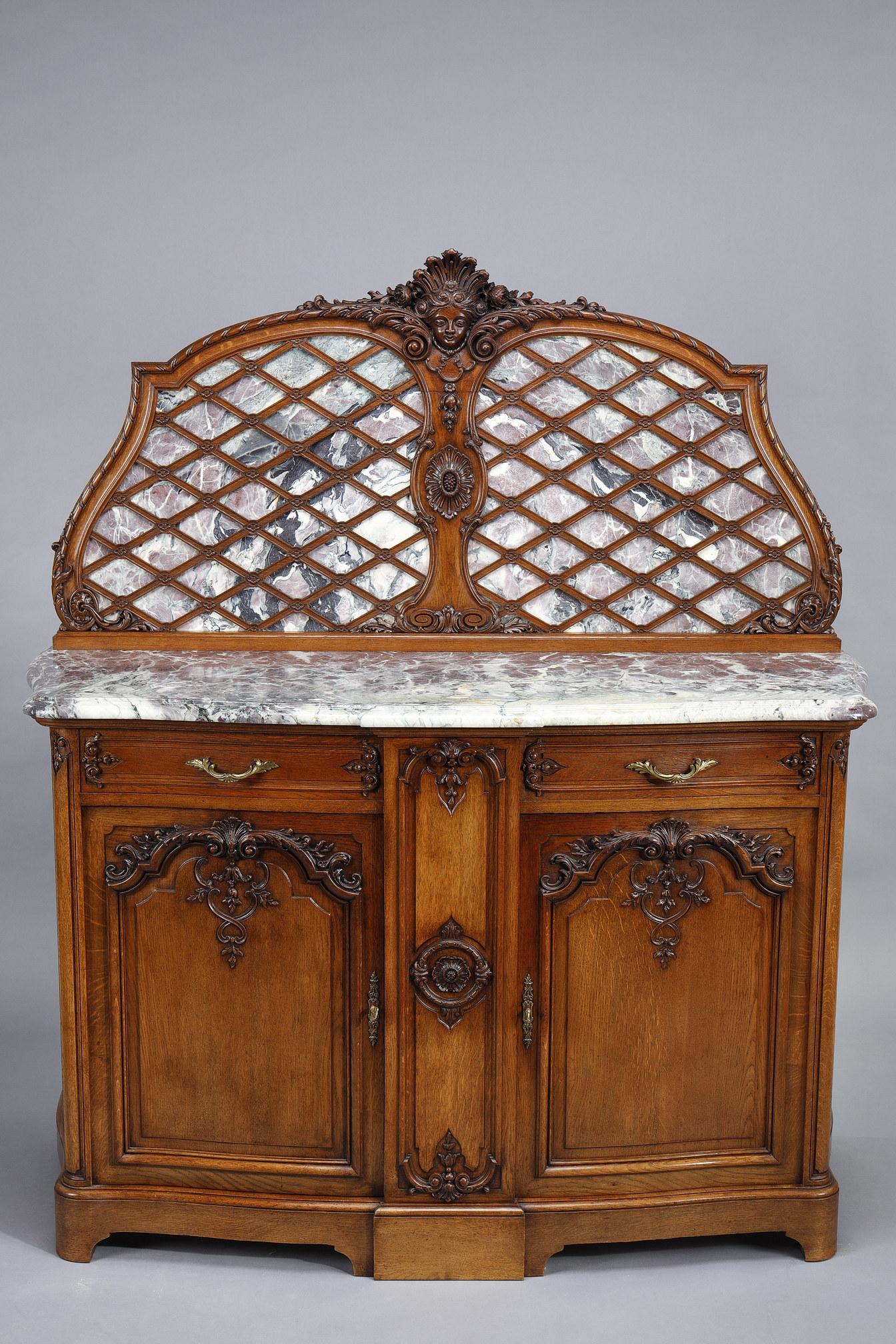 This imposing and beautiful pair of sideboards is part of a rare and important Regency-style dining room set in molded and carved oak. Breche marble top and bottom with a wooden crosspiece. This set is for sale on our website and also includes:
- a