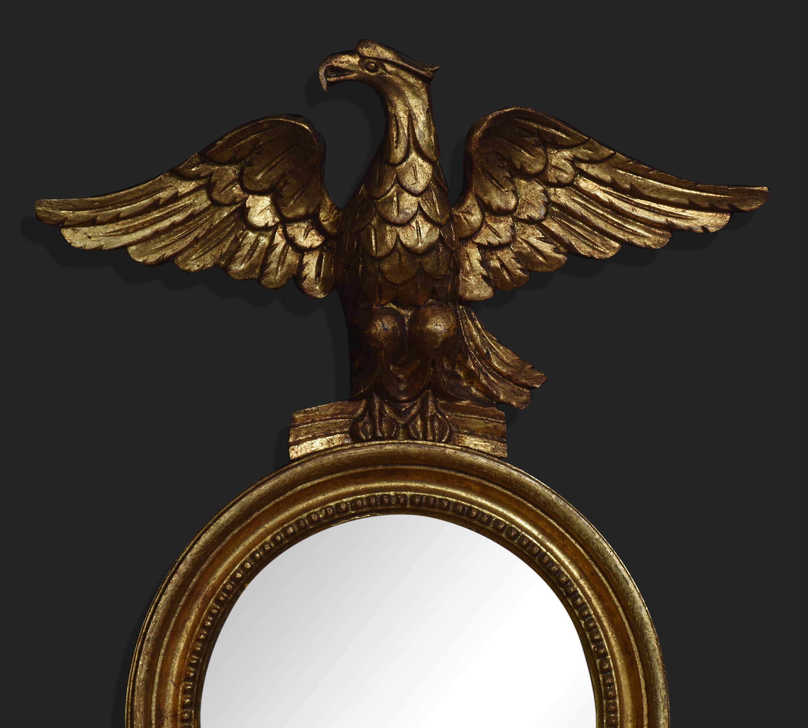 Pair of Regency style wall mirrors, the eagle crest above circular mirror encased in giltwood frame with twin branch light sconces.
Dimensions
Height 32 Inches
Width 14 Inches
Depth 6 Inches