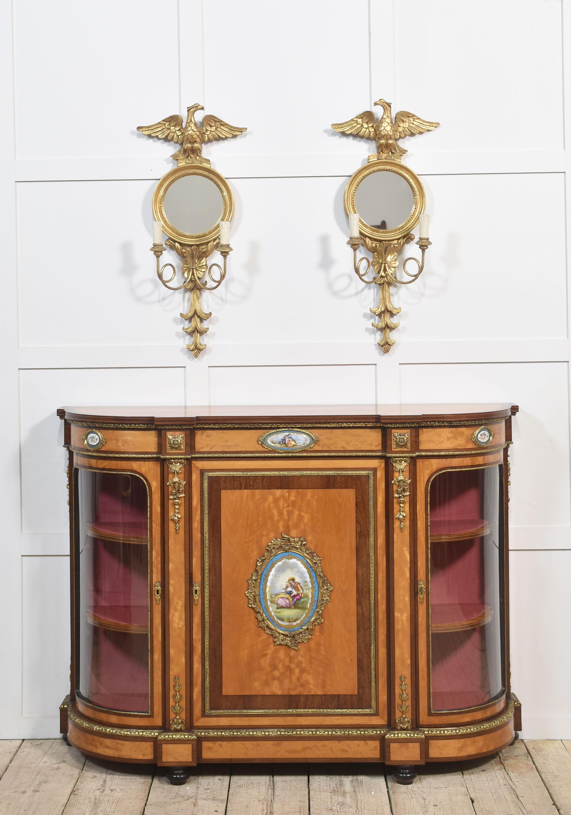 Pair of Regency style wall mirrors, the eagle crest above circular mirror encased in giltwood frame with twin branch light sconces.
Dimensions
Height 32 Inches
Width 14 Inches
Depth 6 Inches